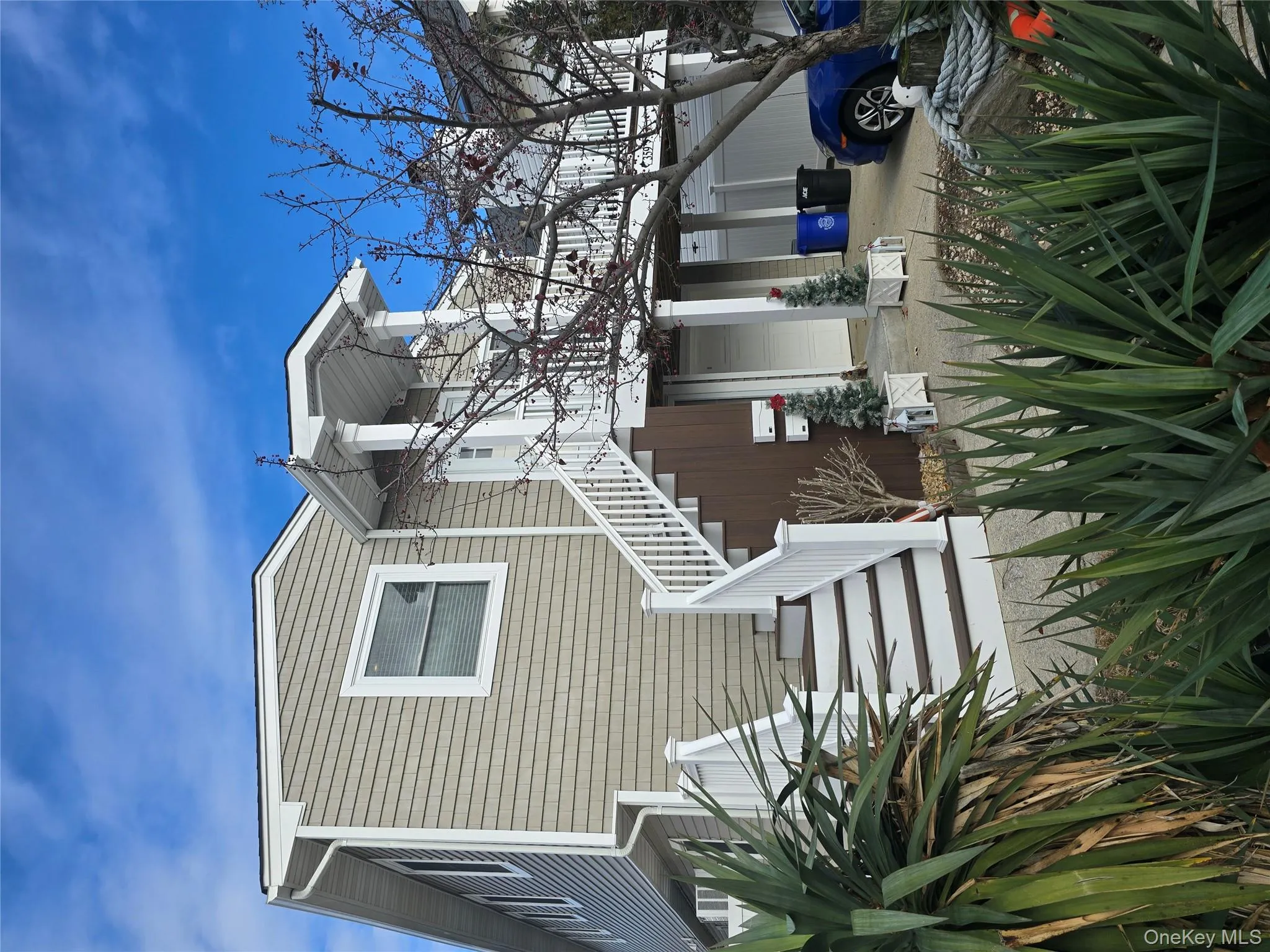 Rear view of property featuring stairs and a garage Rear view of property featuring stairs and a garage