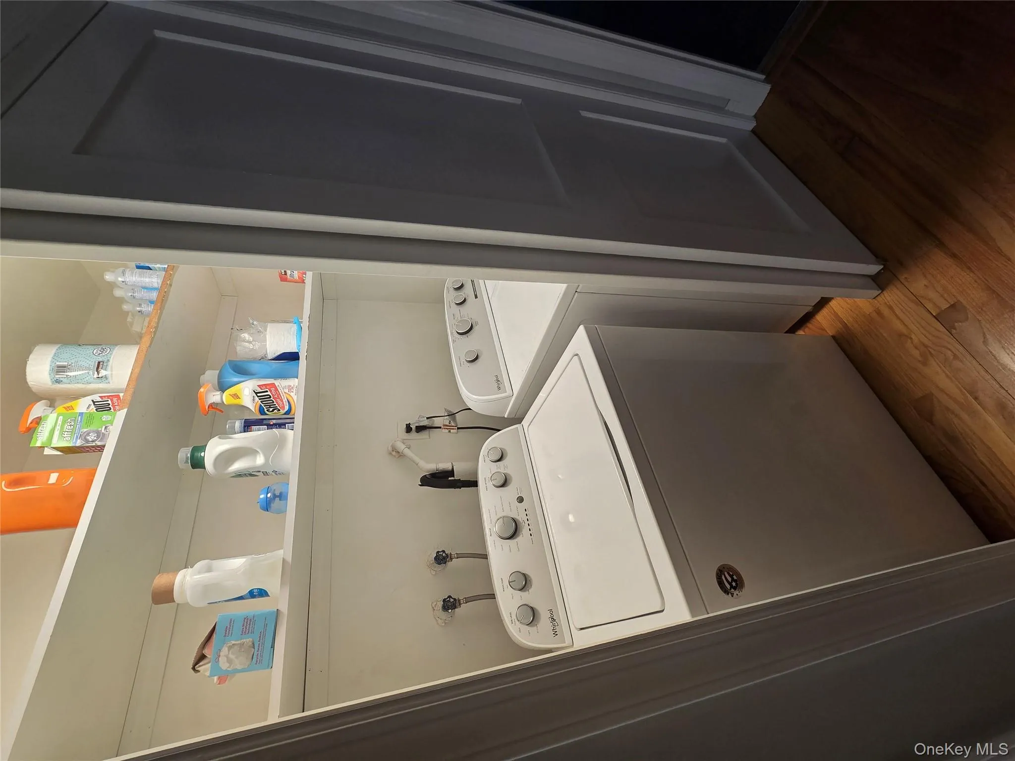 Laundry area featuring dark wood-style floors and washing machine and clothes dryer Laundry area featuring dark wood-style floors and washing machine and clothes dryer