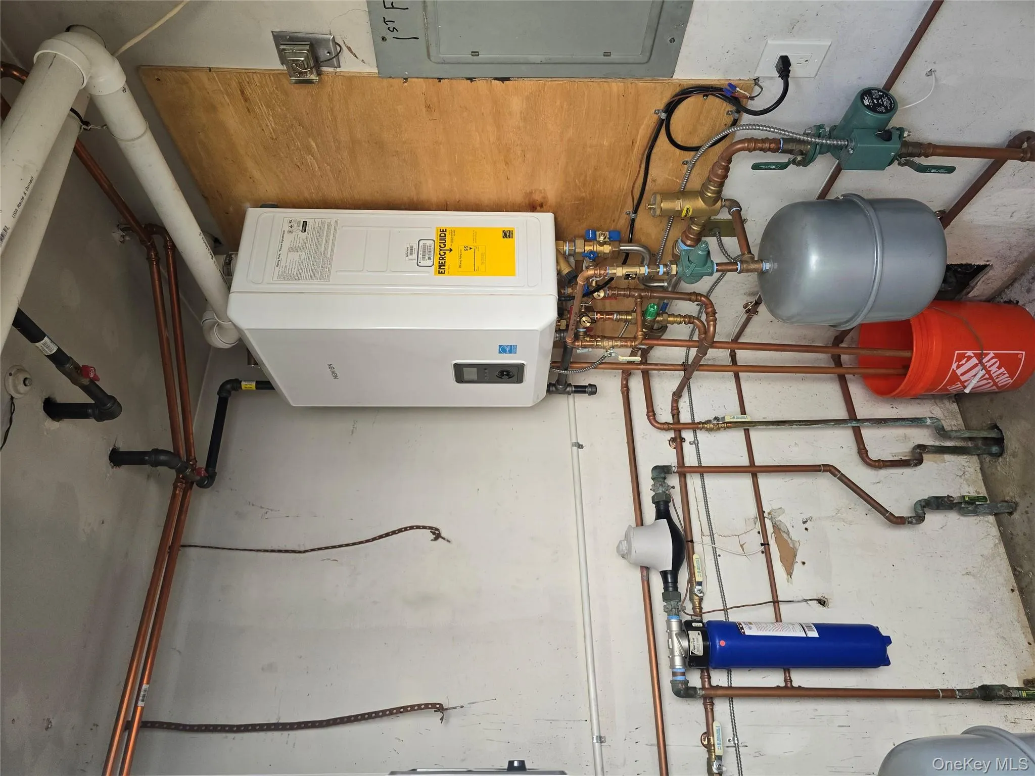 Utility room with water heater and electric panel Utility room with water heater and electric panel