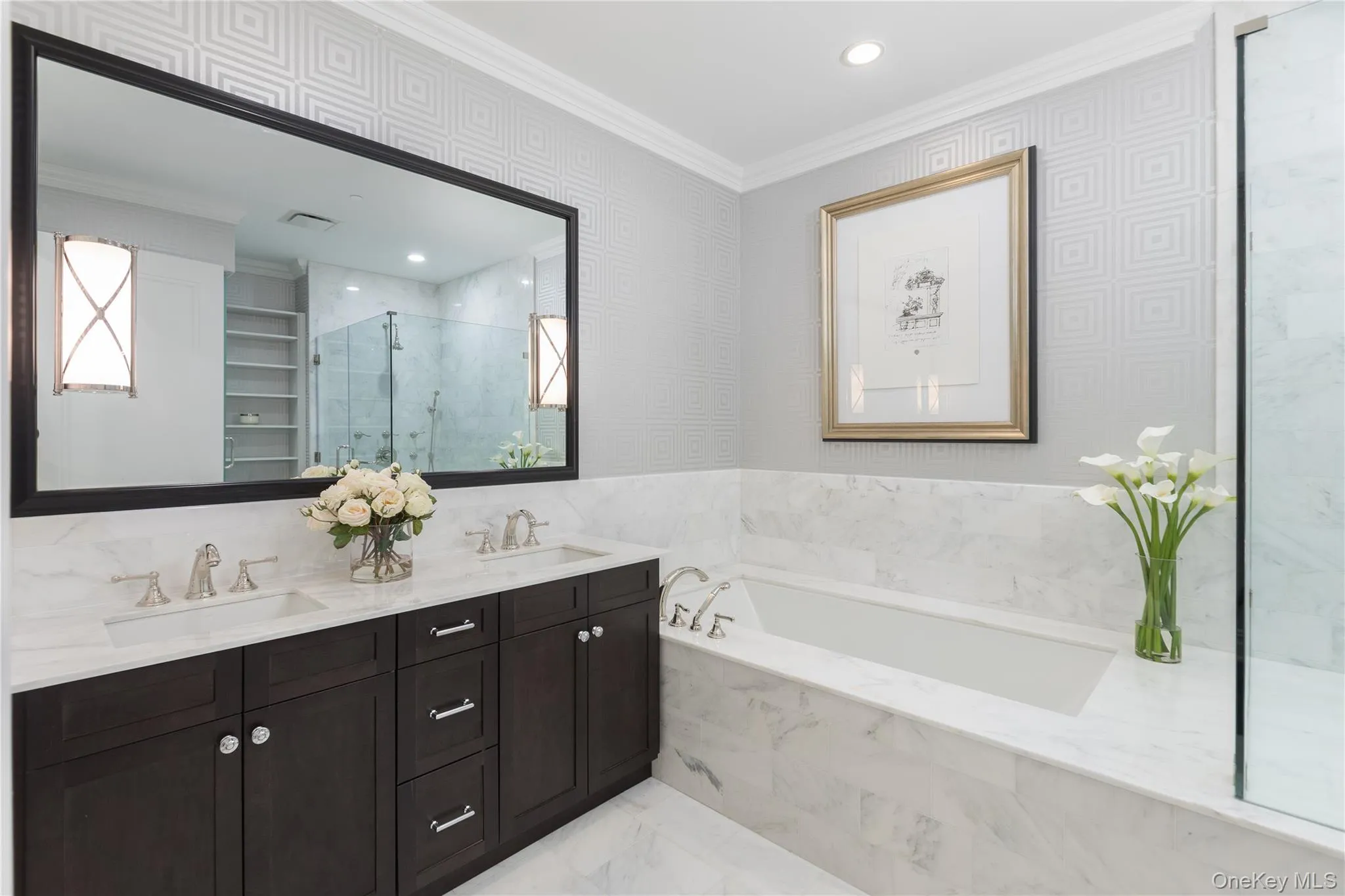 Full bathroom with crown molding, a marble finish shower, double vanity, a garden tub, and wallpapered walls Full bathroom with crown molding, a marble finish shower, double vanity, a garden tub, and wallpapered walls
