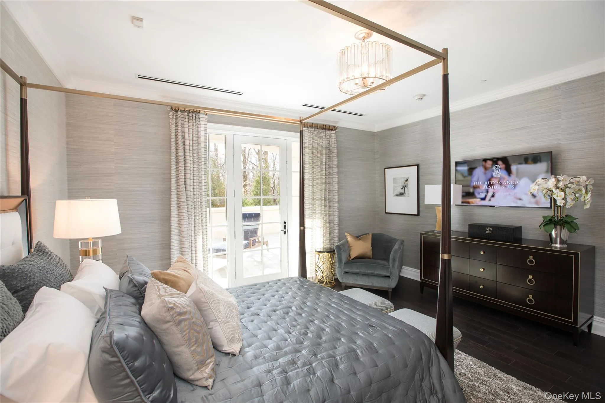 Bedroom featuring crown molding, access to outside, wood finished floors, wallpapered walls, and a chandelier Bedroom featuring crown molding, access to outside, wood finished floors, wallpapered walls, and a chandelier
