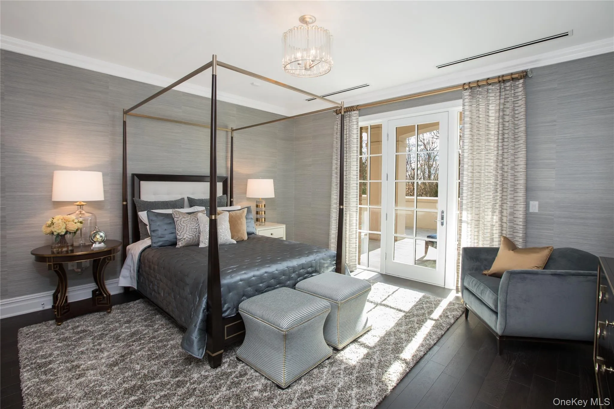 Bedroom featuring crown molding, access to outside, a chandelier, and wallpapered walls Bedroom featuring crown molding, access to outside, a chandelier, and wallpapered walls