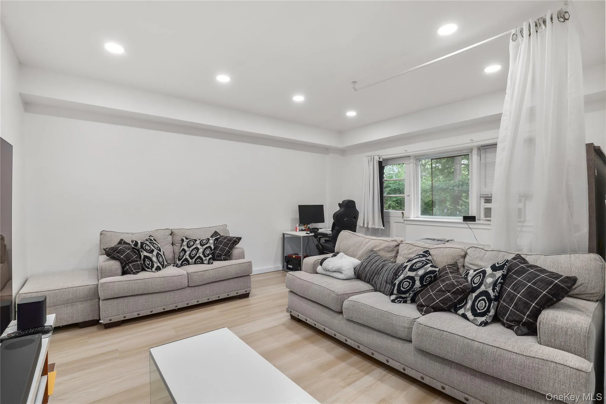 Living area with wood finished floors, recessed lighting, and a desk Living area with wood finished floors, recessed lighting, and a desk