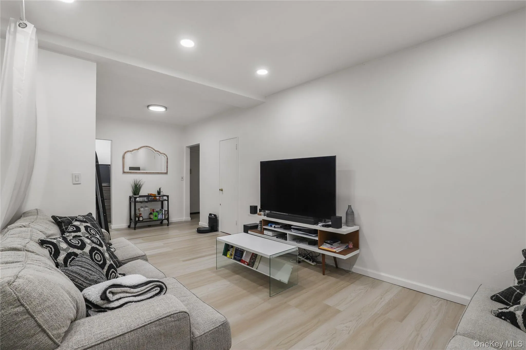Living area featuring light wood-style floors and recessed lighting Living area featuring light wood-style floors and recessed lighting