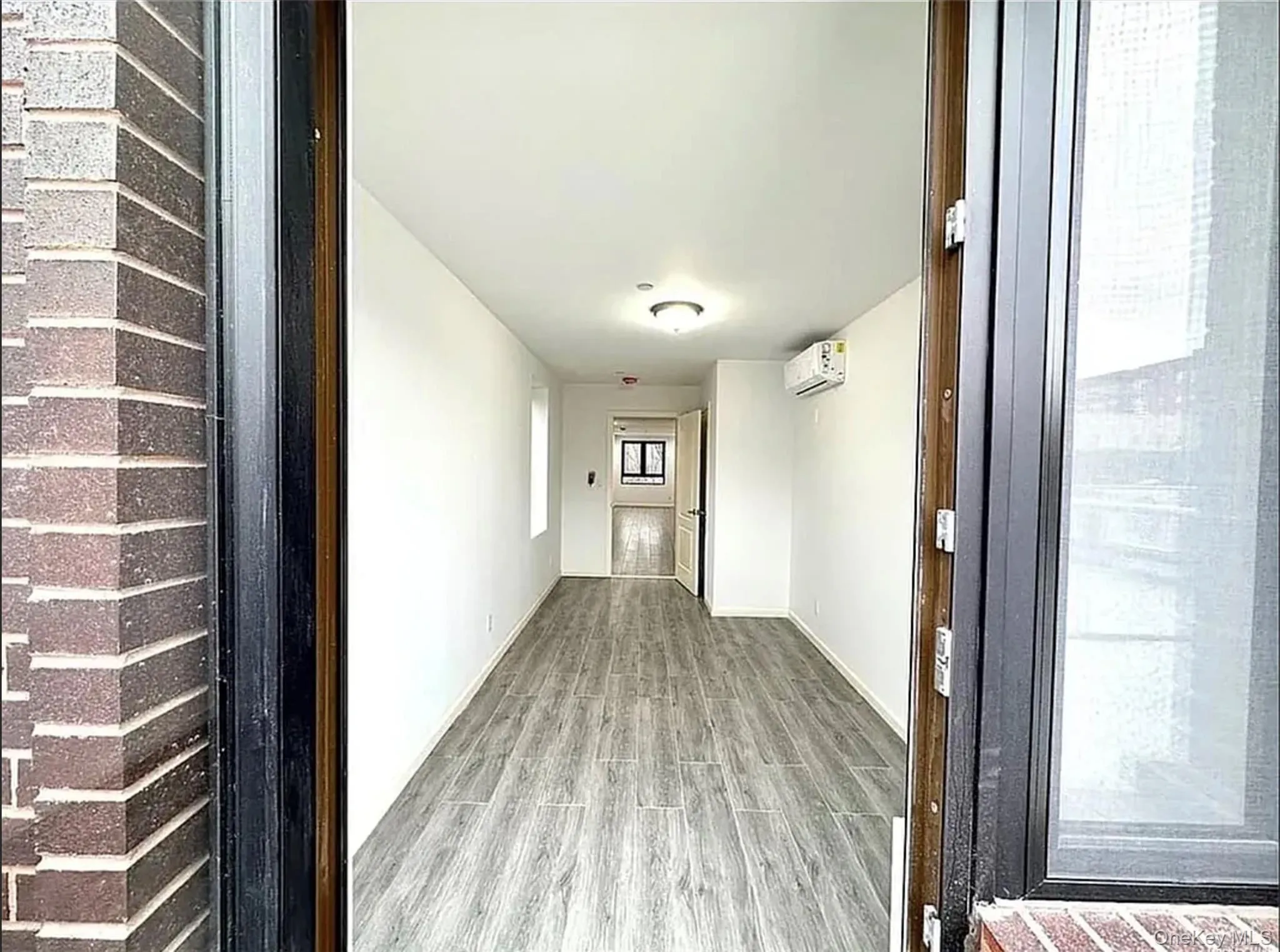 Hall with wood finished floors and baseboards Hall with wood finished floors and baseboards