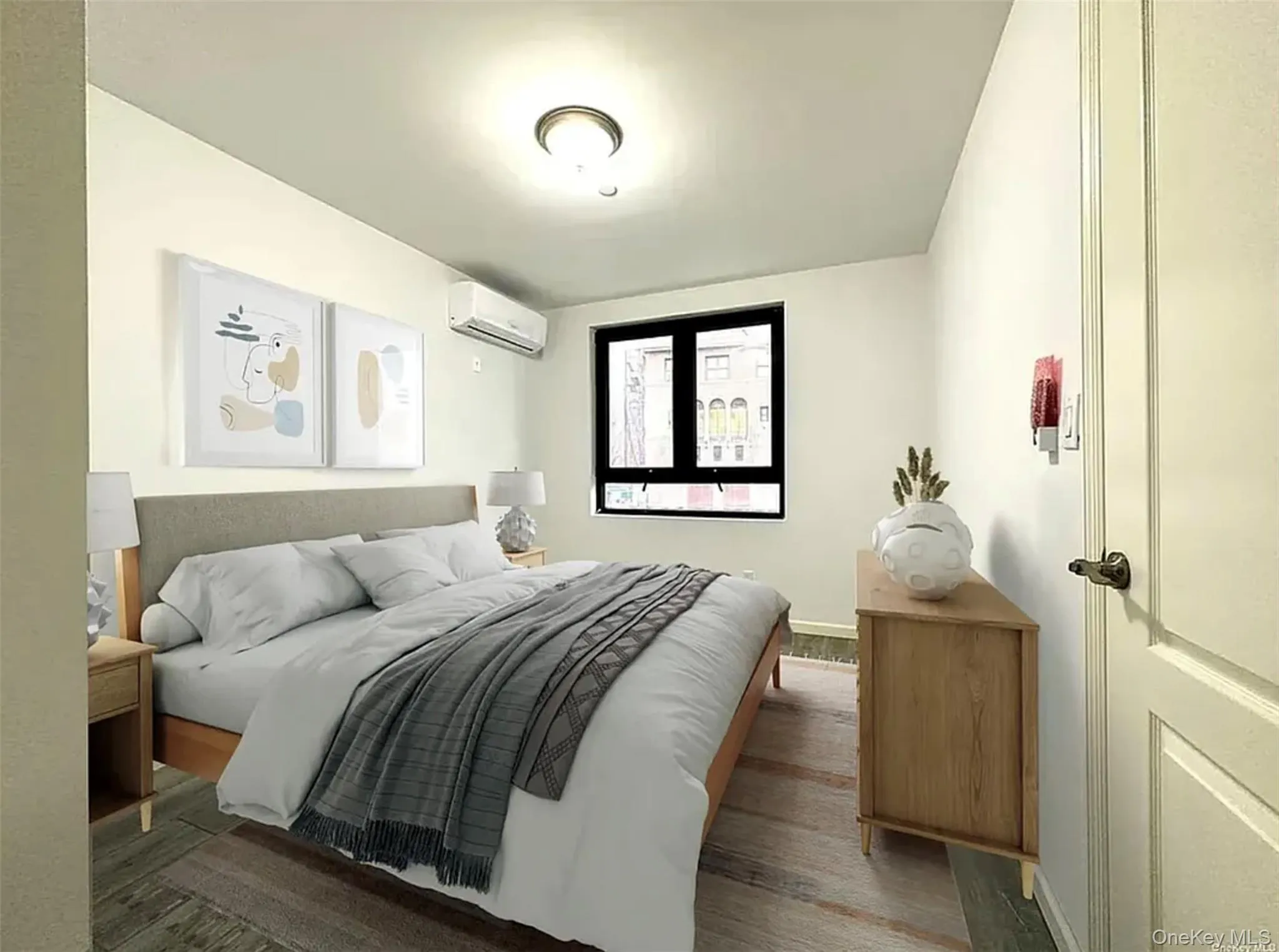 Bedroom featuring wood finished floors and a wall mounted AC Bedroom featuring wood finished floors and a wall mounted AC