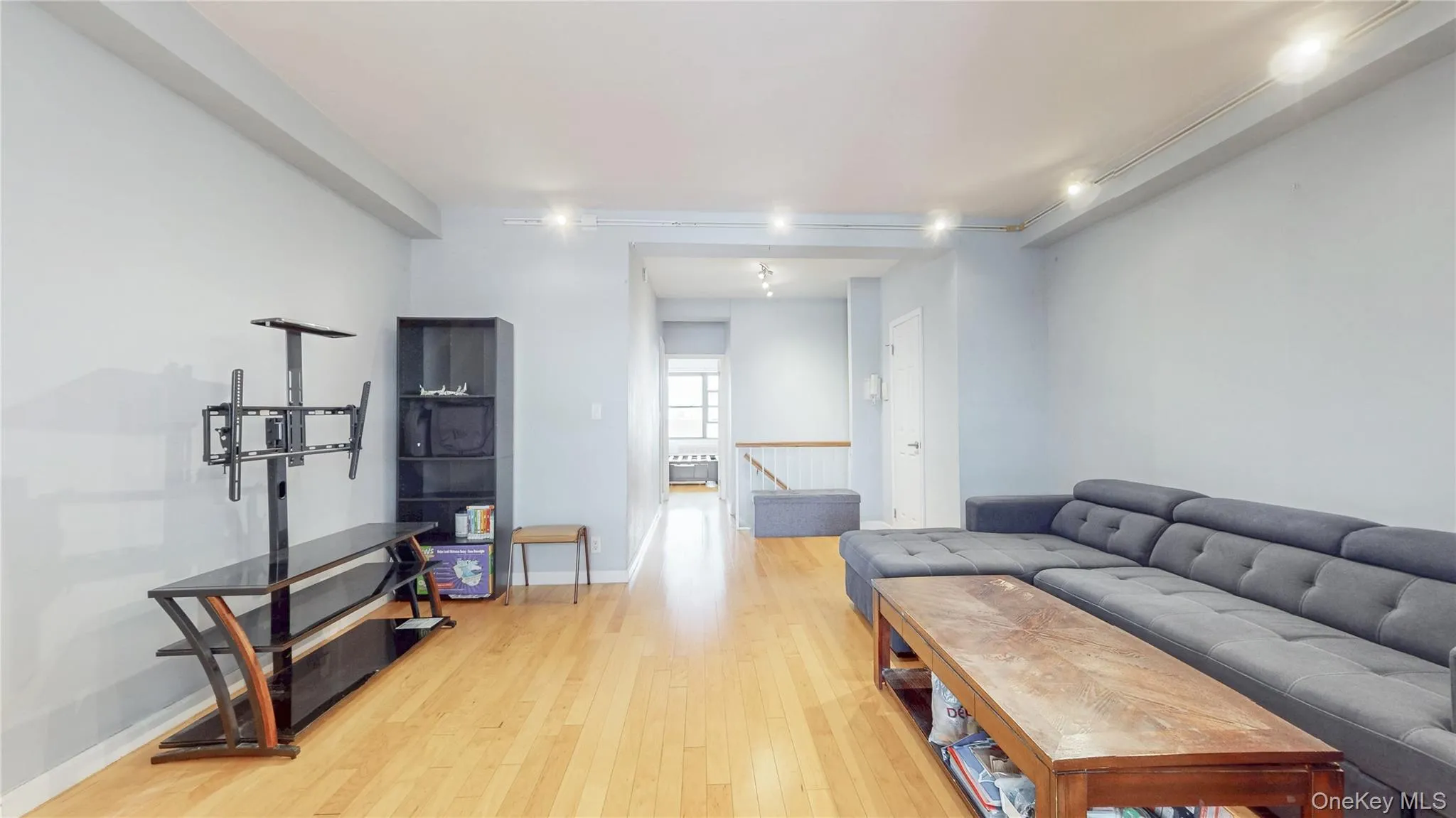 Living room with light wood-style floors and baseboards Living room with light wood-style floors and baseboards