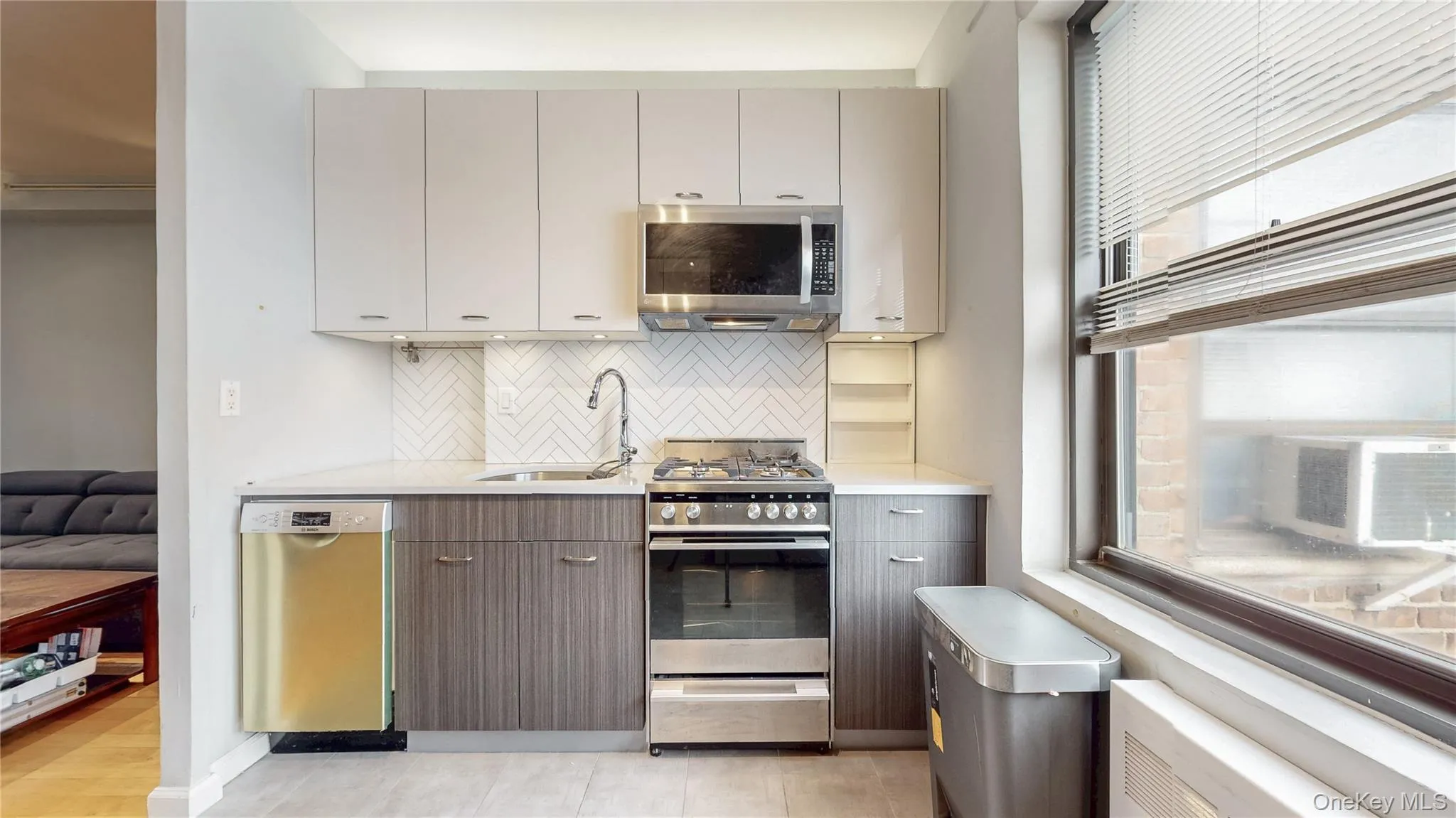 Kitchen with plenty of natural light, stainless steel appliances, modern cabinets, and tasteful backsplash Kitchen with plenty of natural light, stainless steel appliances, modern cabinets, and tasteful backsplash