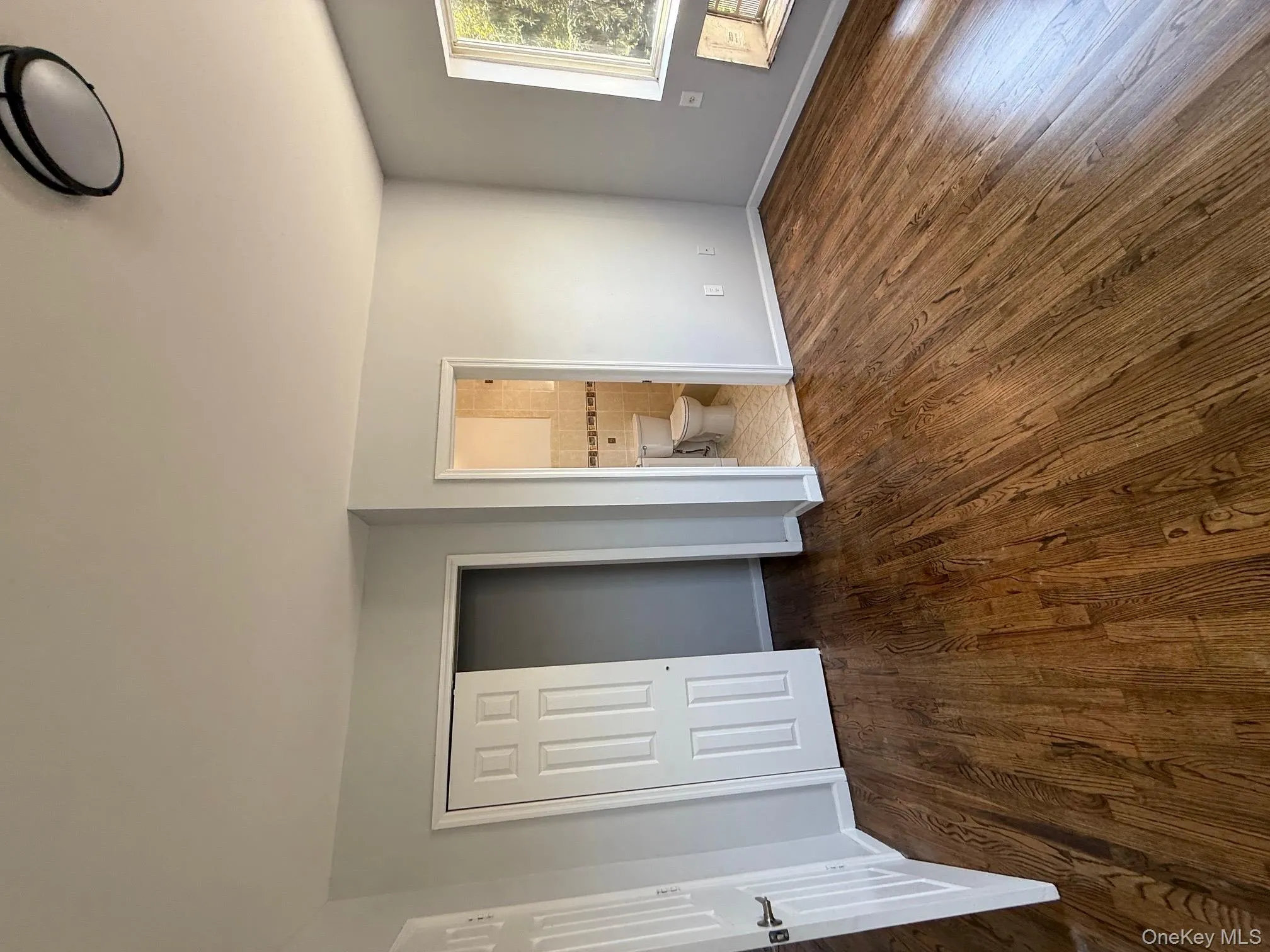 Unfurnished bedroom featuring dark wood-style flooring, a closet, and ensuite bath Unfurnished bedroom featuring dark wood-style flooring, a closet, and ensuite bath