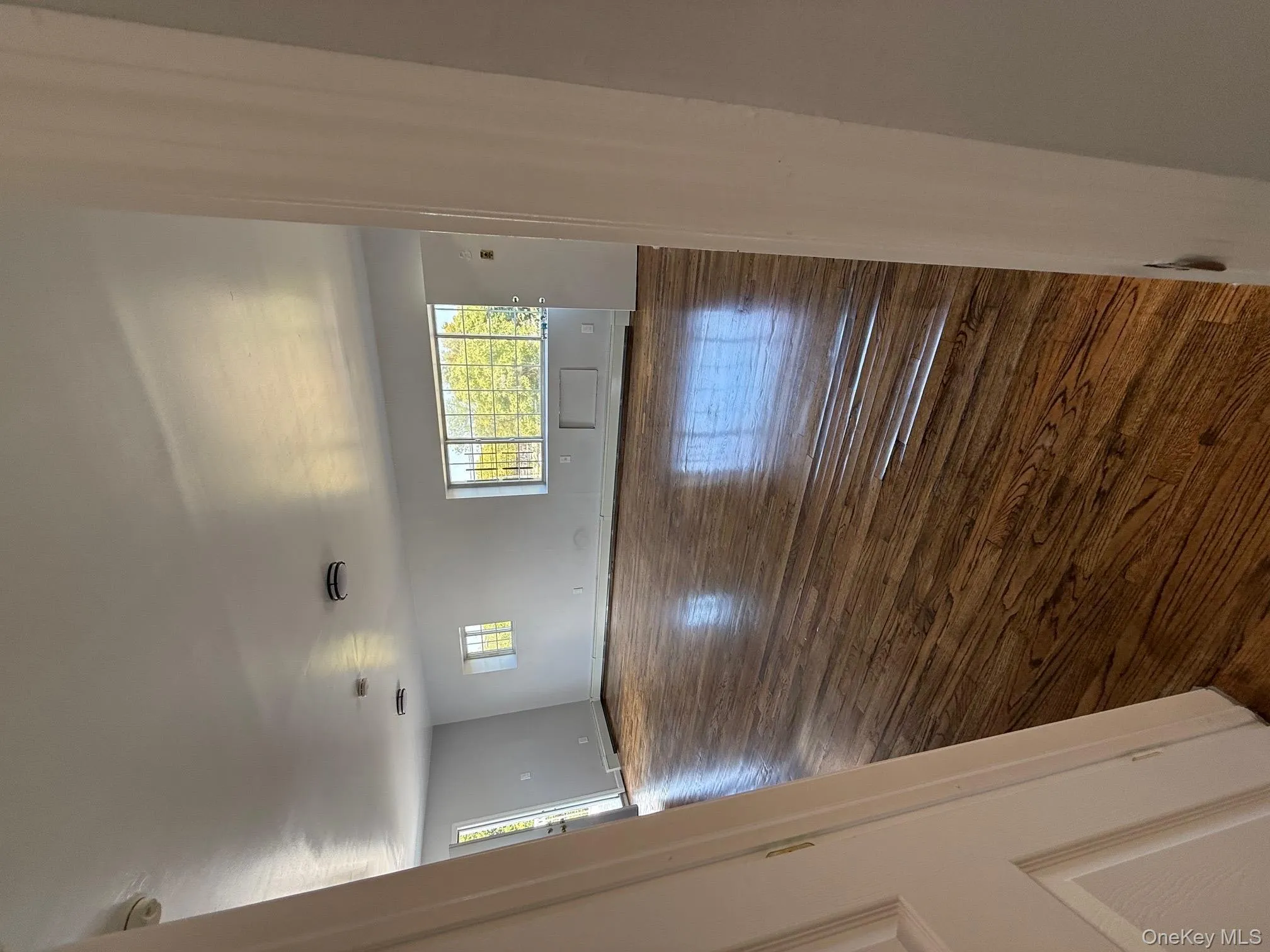 Unfurnished room with dark wood finished floors and a baseboard radiator Unfurnished room with dark wood finished floors and a baseboard radiator