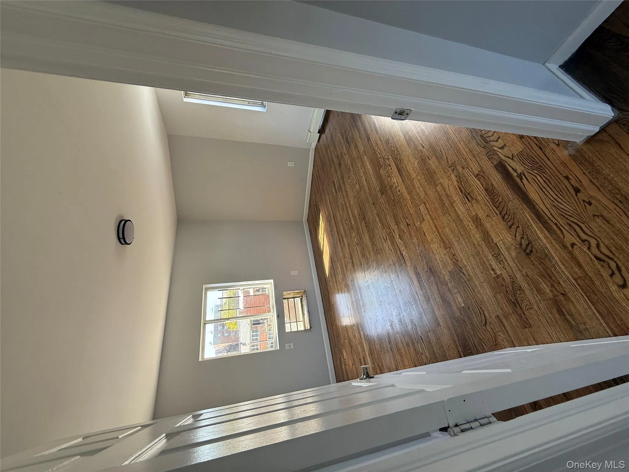 Spare room featuring dark wood finished floors and a baseboard radiator Spare room featuring dark wood finished floors and a baseboard radiator