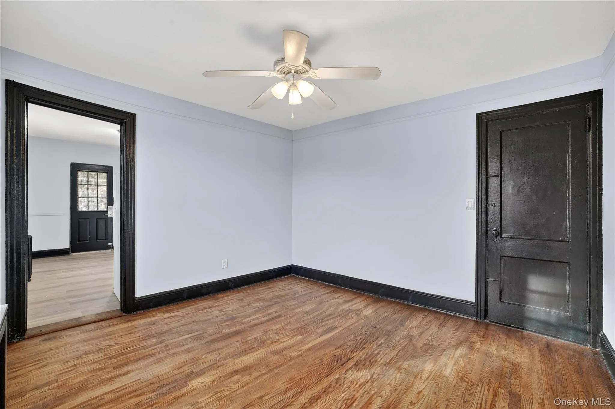 Spare room with wood finished floors and ceiling fan Spare room with wood finished floors and ceiling fan