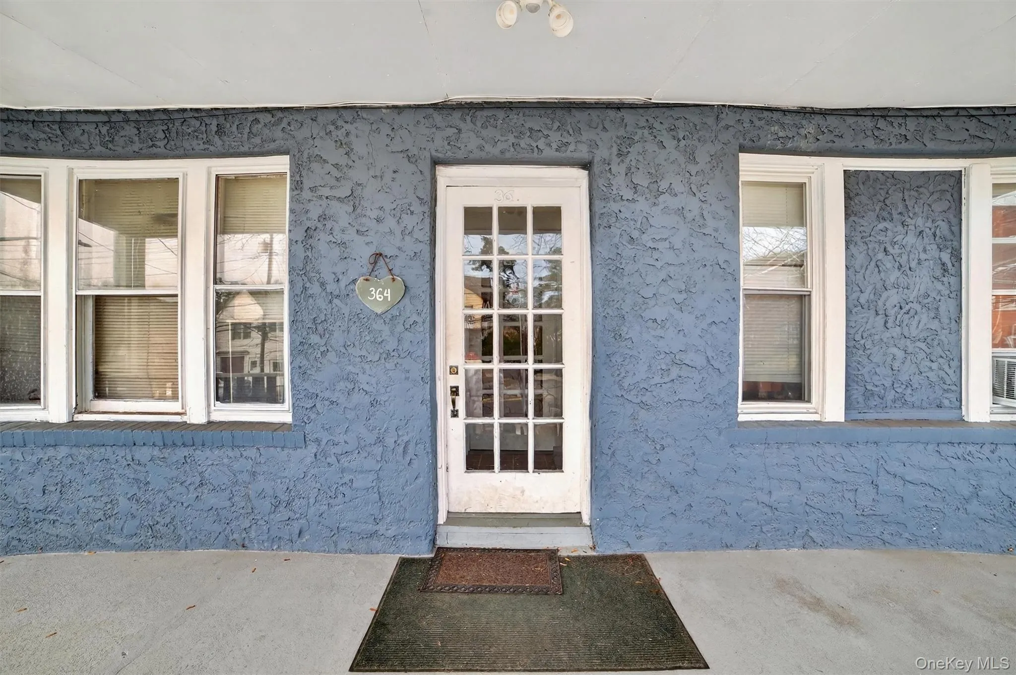 View of exterior entry featuring stucco siding View of exterior entry featuring stucco siding