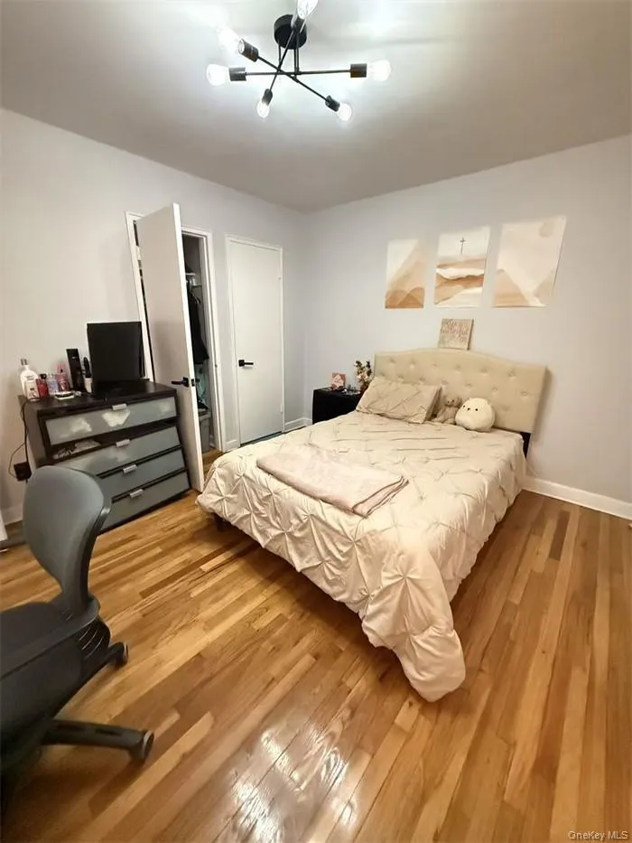 Bedroom featuring light wood-type flooring and baseboards Bedroom featuring light wood-type flooring and baseboards