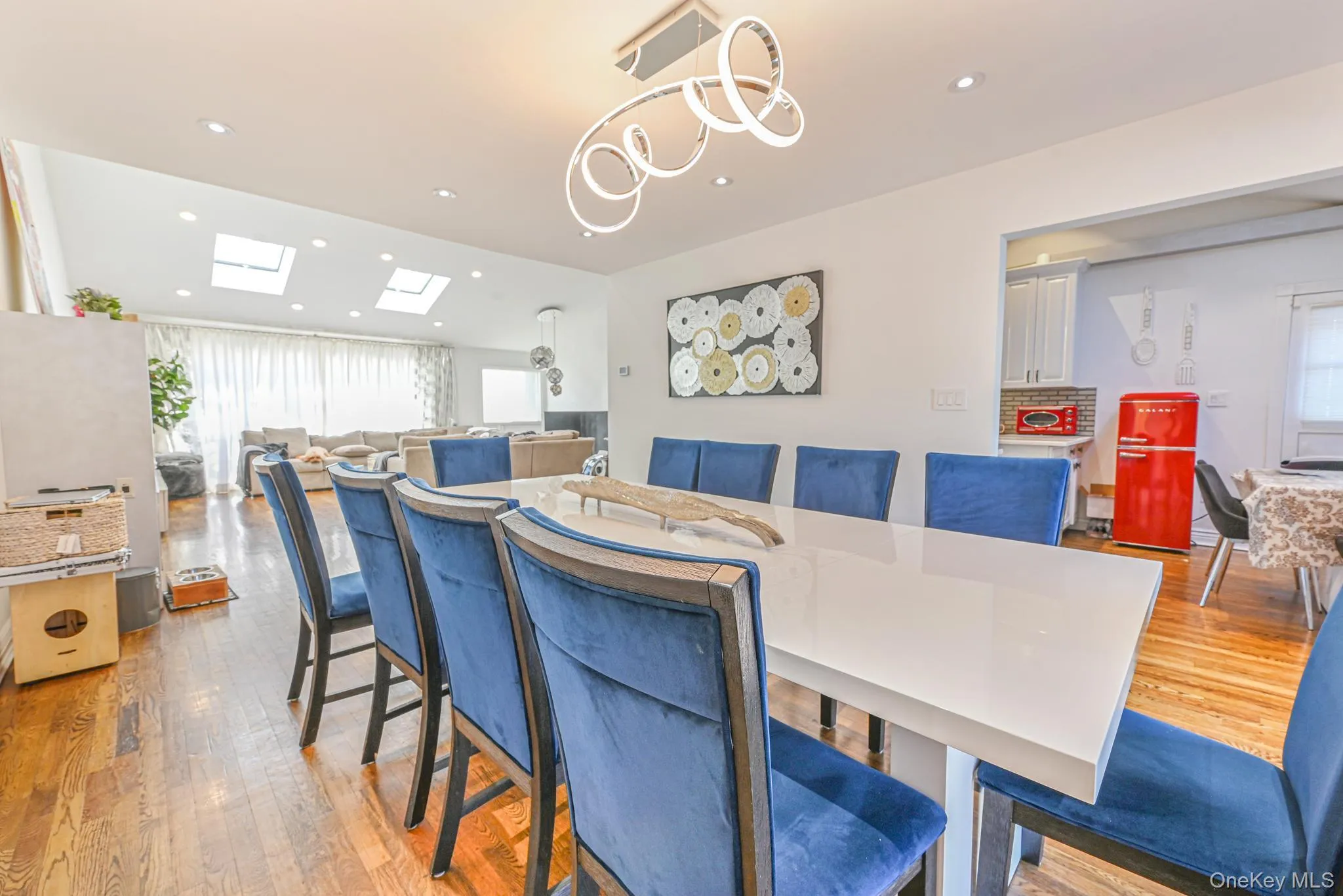 Dining area featuring recessed lighting, plenty of natural light, hardwood / wood-style floors, and a skylight Dining area featuring recessed lighting, plenty of natural light, hardwood / wood-style floors, and a skylight