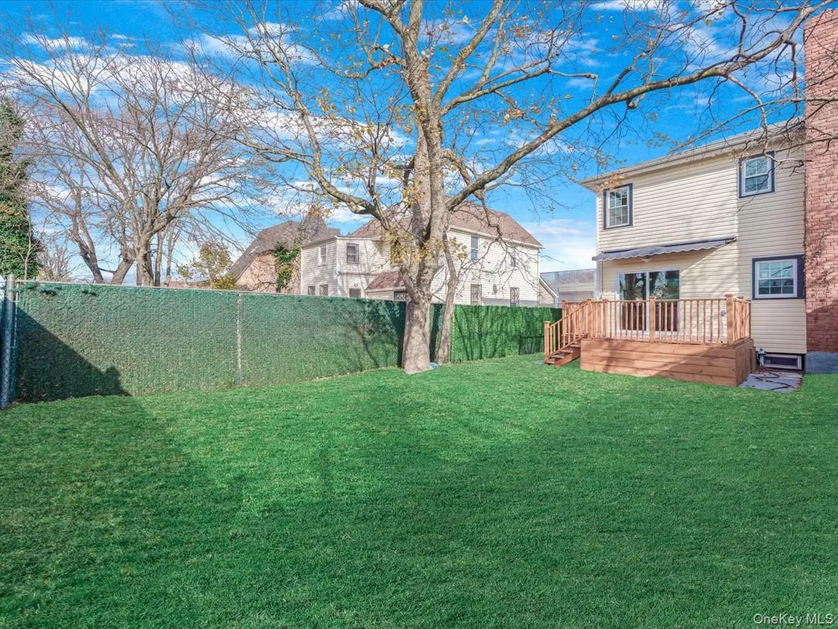 Fenced backyard with a wooden deck Fenced backyard with a wooden deck