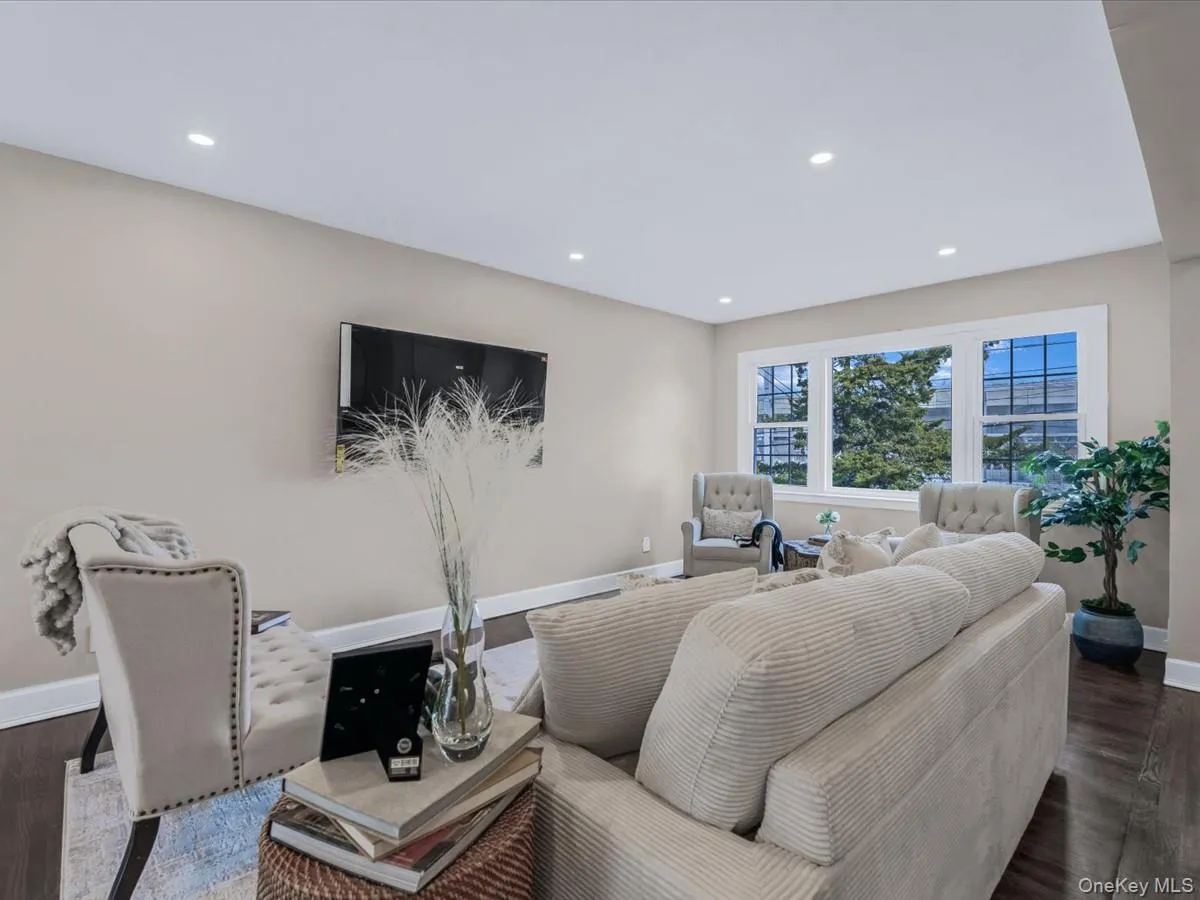 Living area featuring dark wood-style flooring and recessed lighting Living area featuring dark wood-style flooring and recessed lighting