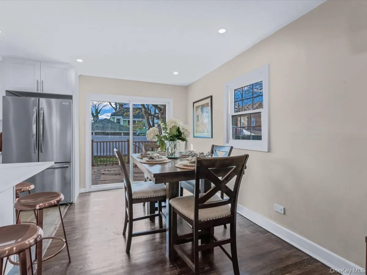 Dining room with dark wood-type flooring and recessed lighting Dining room with dark wood-type flooring and recessed lighting