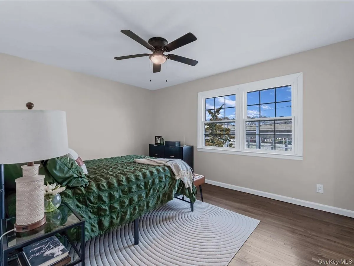 Bedroom with wood finished floors and ceiling fan Bedroom with wood finished floors and ceiling fan