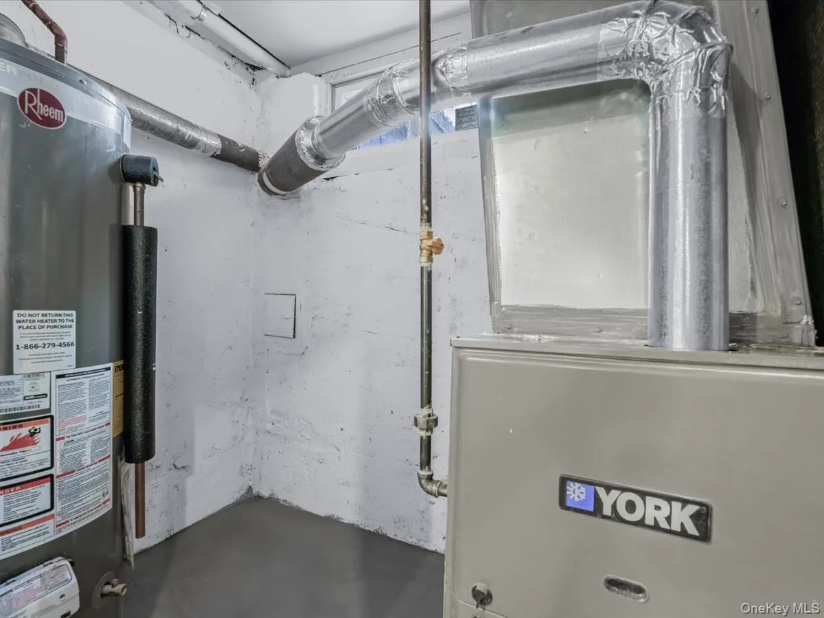 Utility room featuring gas water heater and heating unit Utility room featuring gas water heater and heating unit