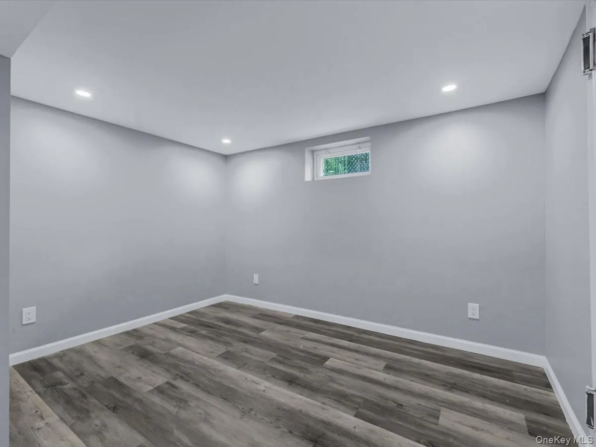 Basement featuring wood finished floors and recessed lighting Basement featuring wood finished floors and recessed lighting