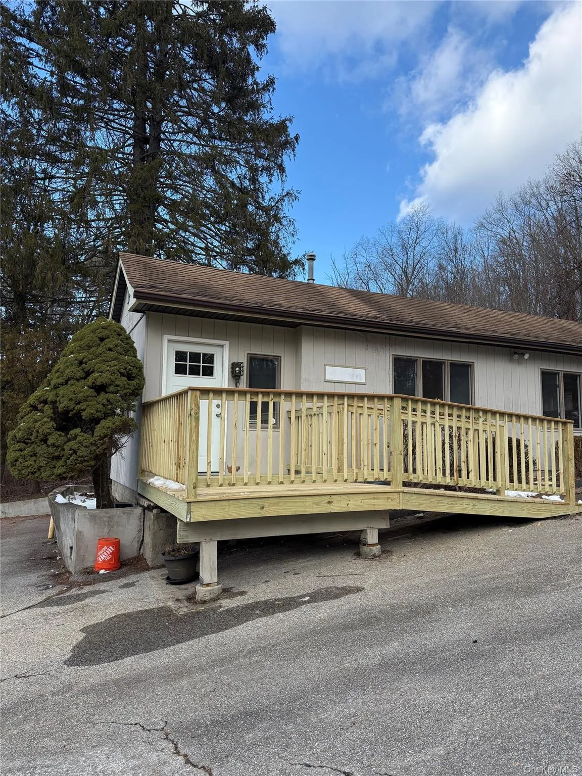 View of front of property featuring roof with shingles and a deck View of front of property featuring roof with shingles and a deck