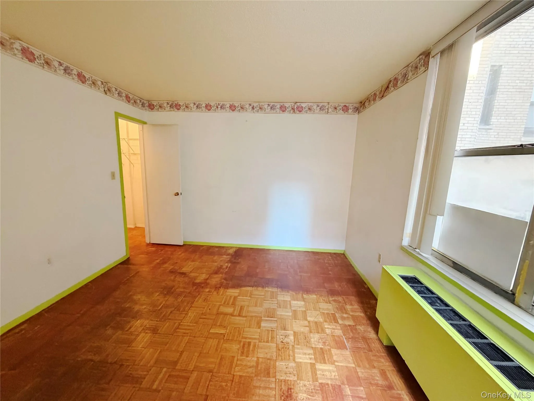 Unfurnished room with baseboards and radiator Unfurnished room with baseboards and radiator