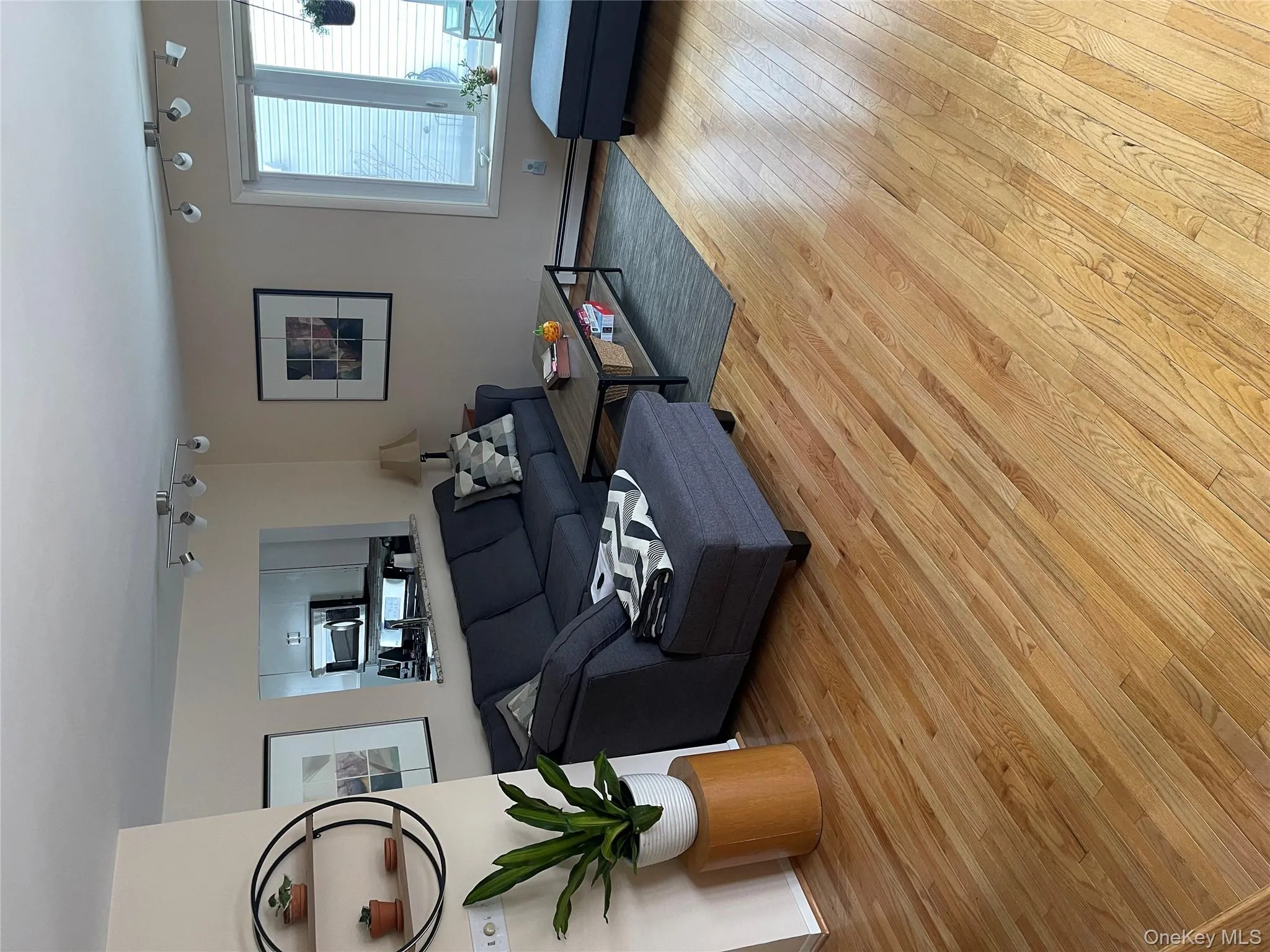 Living room featuring light wood finished floors and baseboard heating Living room featuring light wood finished floors and baseboard heating