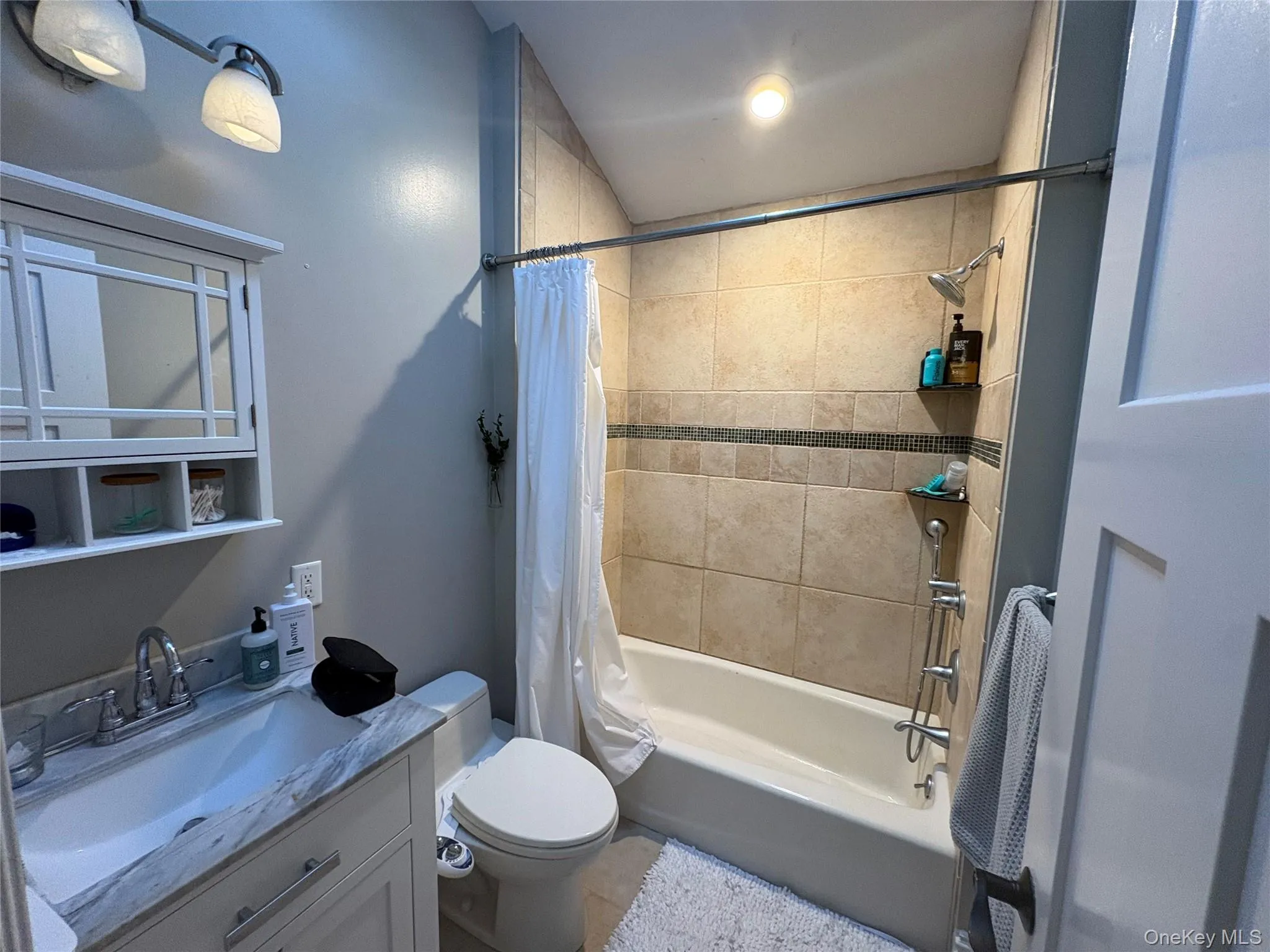 Full bathroom featuring shower / bath combo with shower curtain and vanity Full bathroom featuring shower / bath combo with shower curtain and vanity