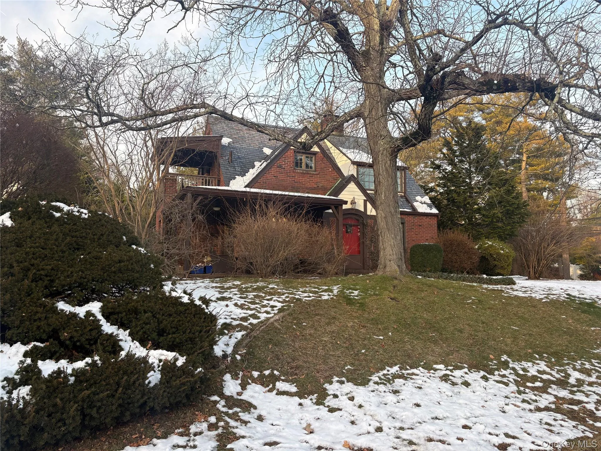 View of snow covered exterior featuring brick siding View of snow covered exterior featuring brick siding