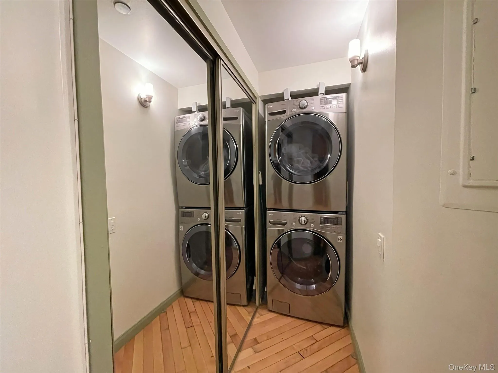 Washroom with light wood-style floors and electric panel Washroom with light wood-style floors and electric panel