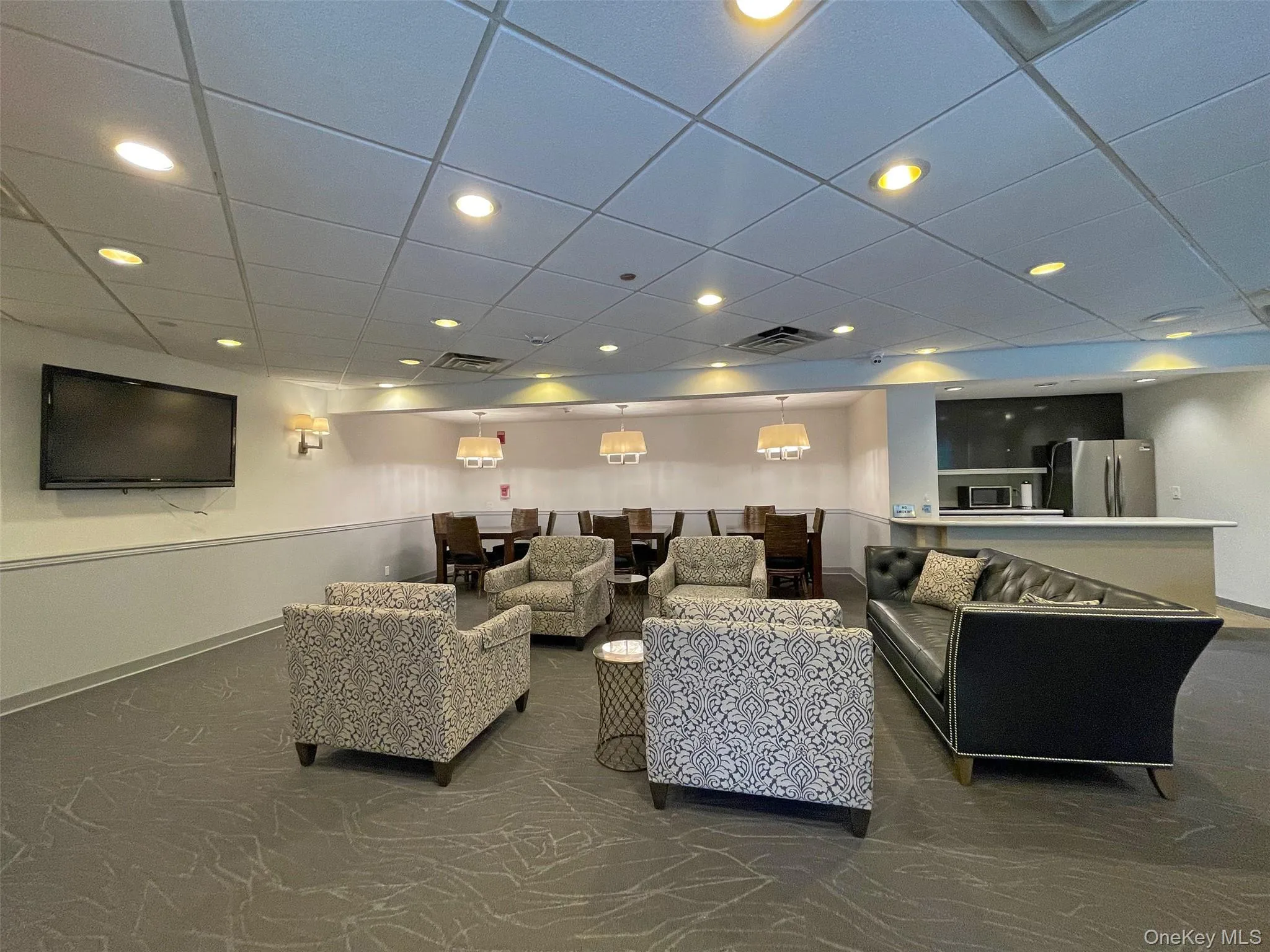 Living room featuring a paneled ceiling and recessed lighting Living room featuring a paneled ceiling and recessed lighting