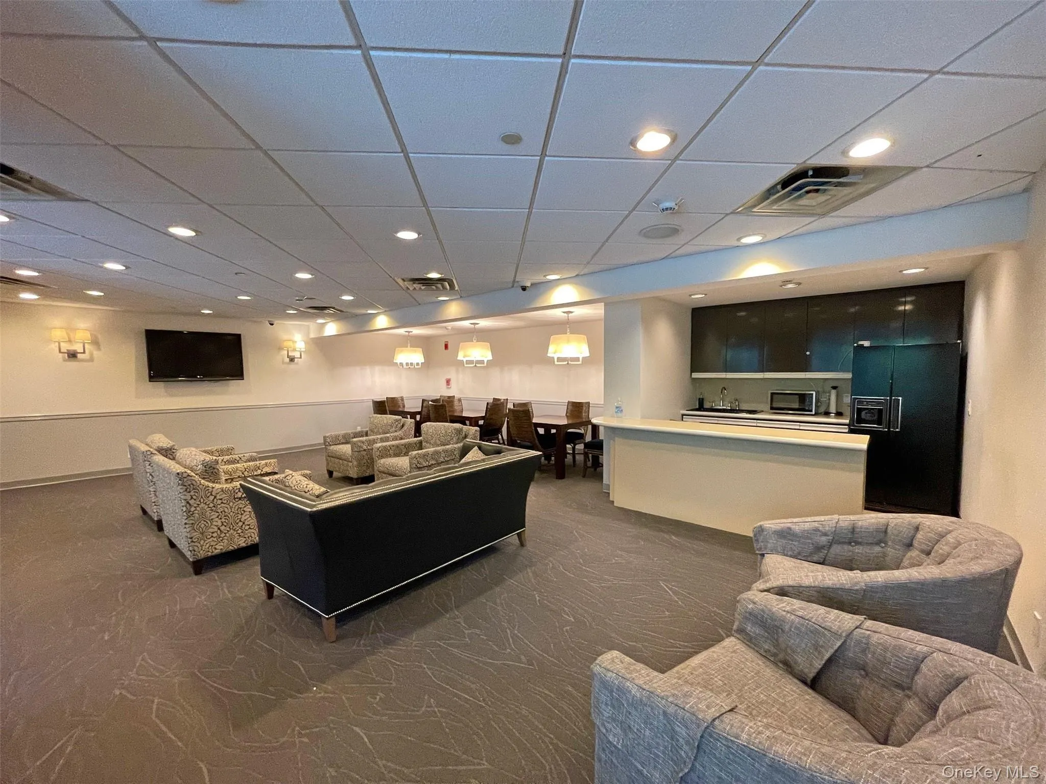 Living room with a paneled ceiling and recessed lighting Living room with a paneled ceiling and recessed lighting