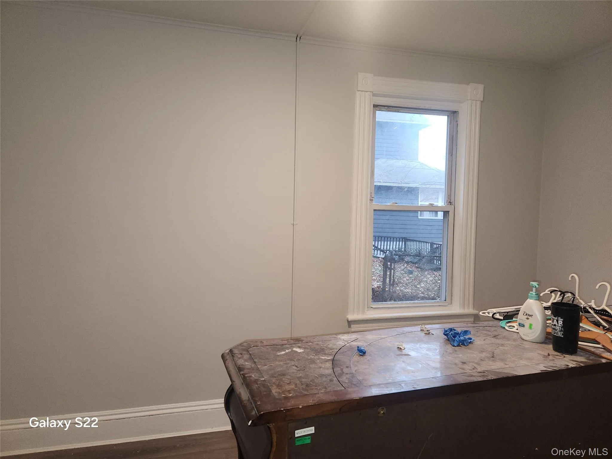 Office area with dark wood-type flooring and ornamental molding Office area with dark wood-type flooring and ornamental molding