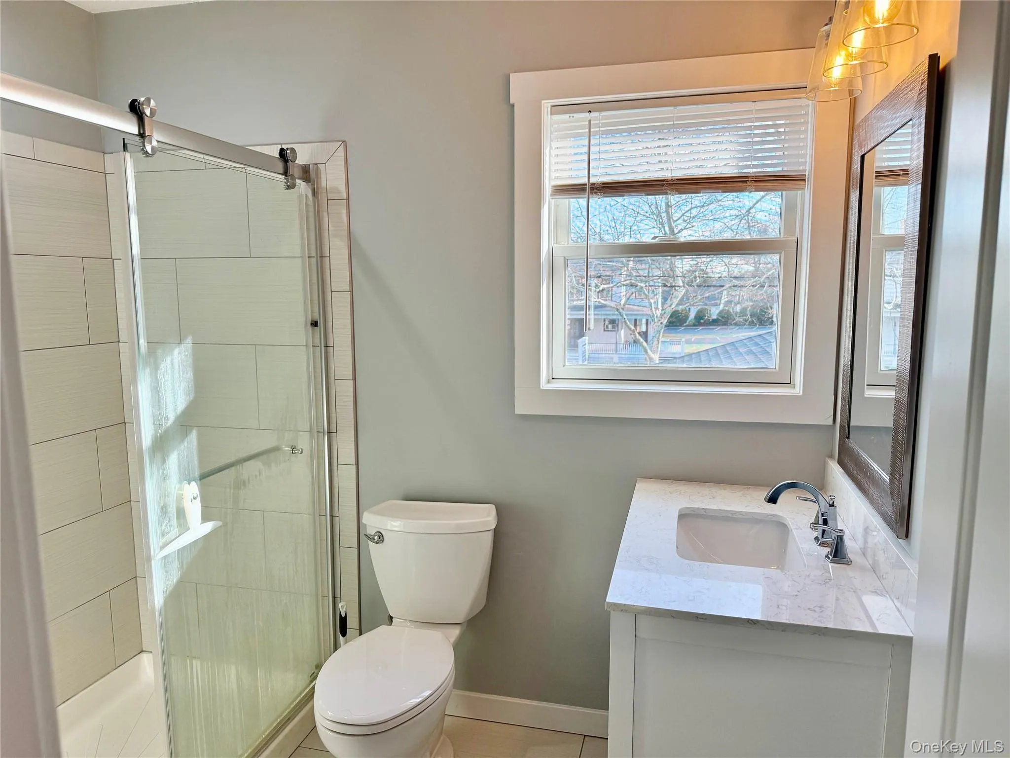Bathroom with vanity and a shower stall Bathroom with vanity and a shower stall