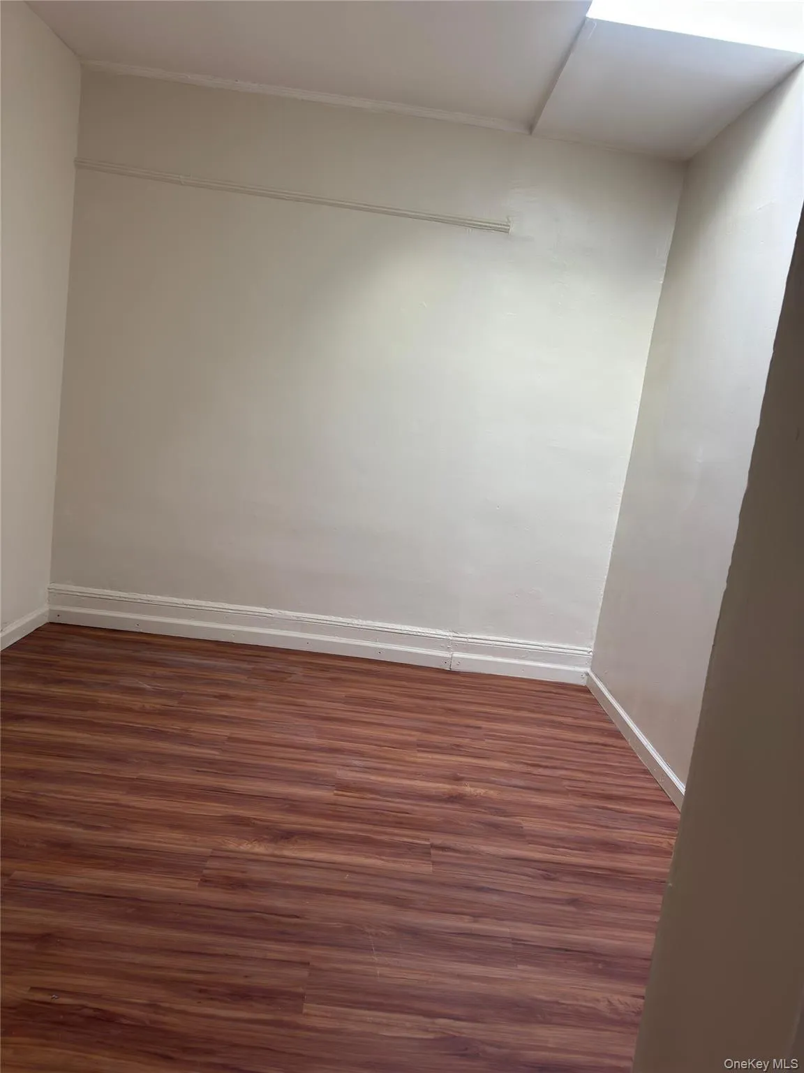 Spare room featuring dark wood-style floors Spare room featuring dark wood-style floors