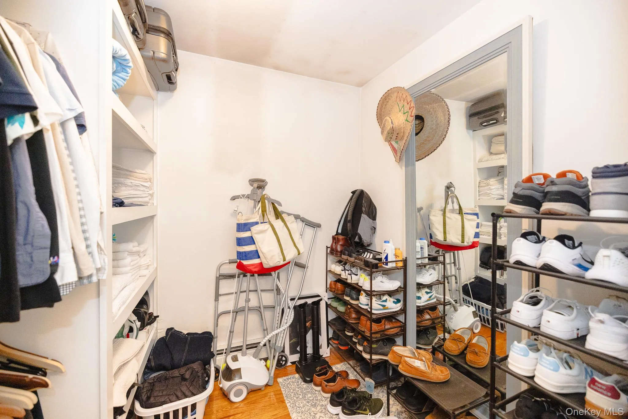 Spacious closet featuring light wood finished floors Spacious closet featuring light wood finished floors