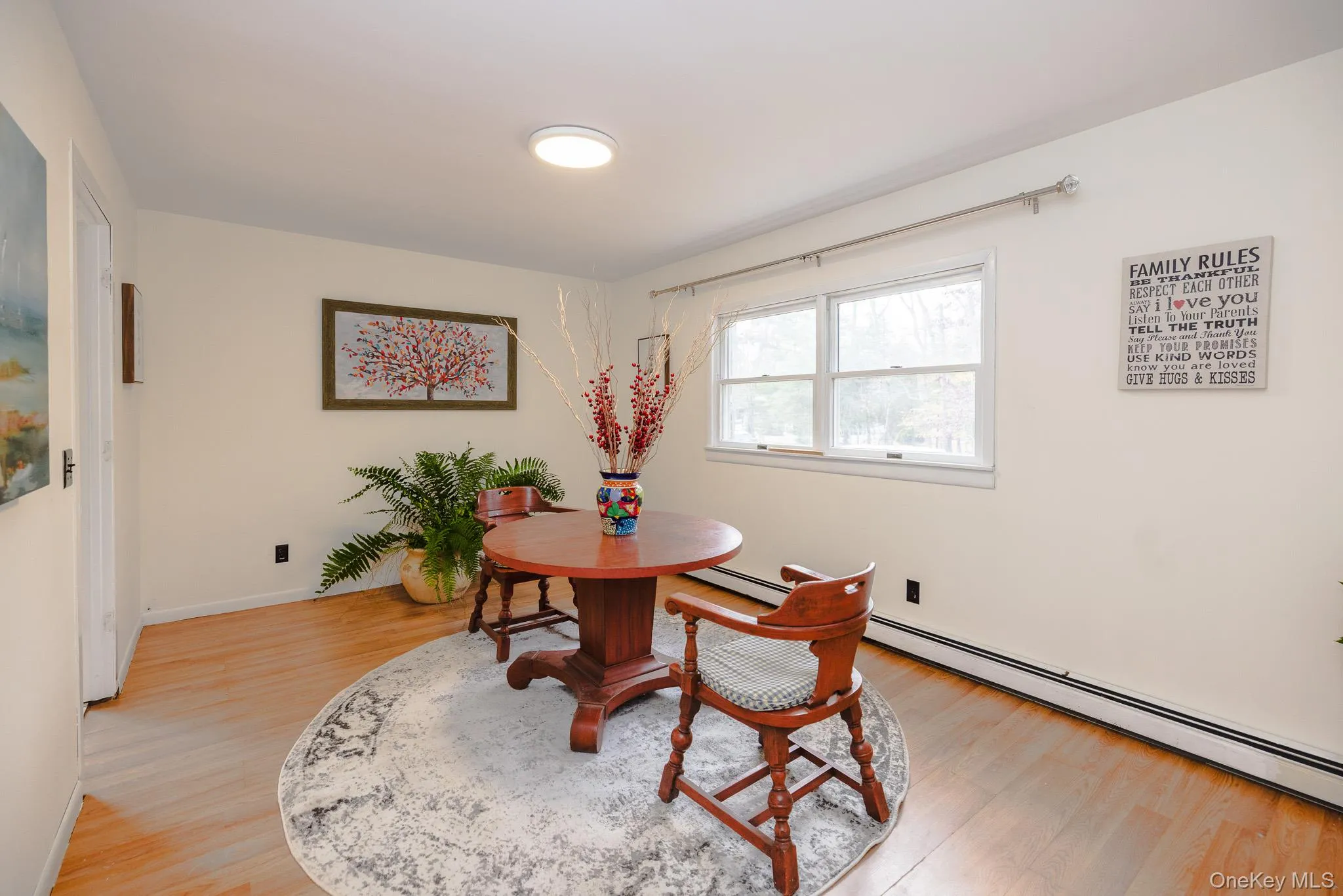 Dining room featuring light wood finished floors and a baseboard radiator Dining room featuring light wood finished floors and a baseboard radiator