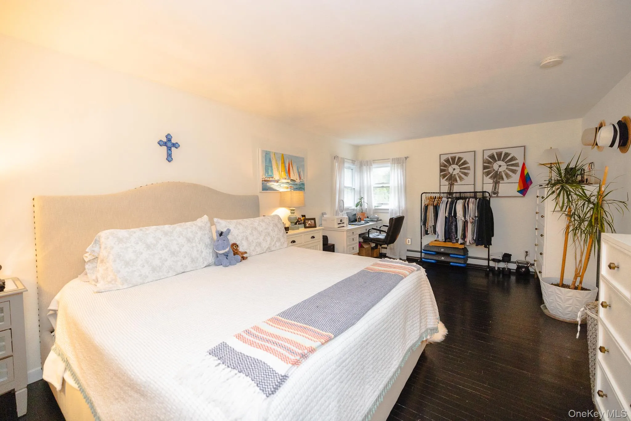 Bedroom featuring dark wood-type flooring and a desk Bedroom featuring dark wood-type flooring and a desk