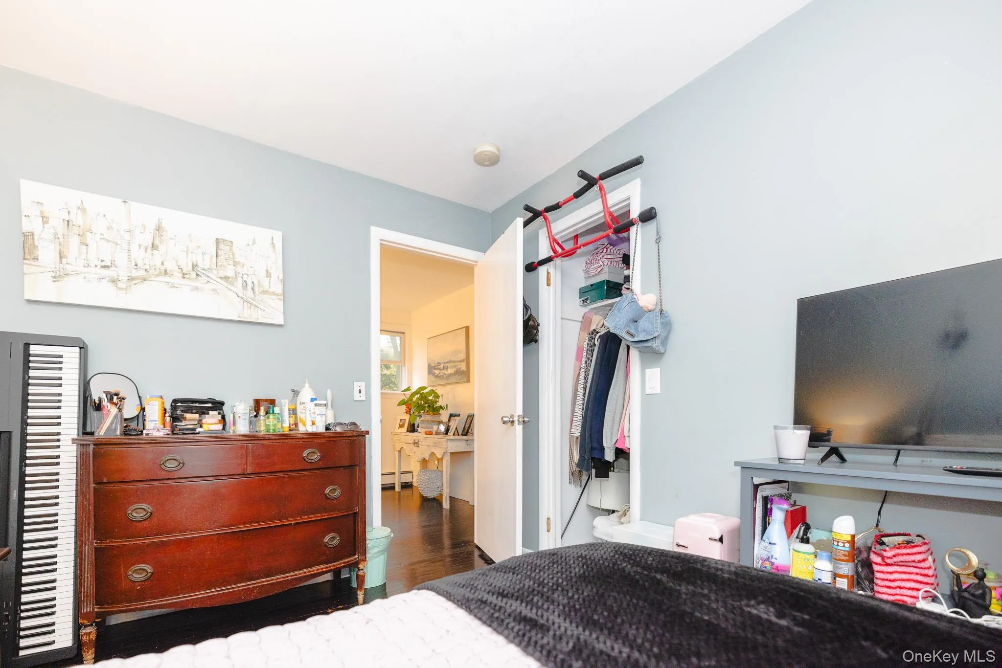 Bedroom with wood finished floors and a closet Bedroom with wood finished floors and a closet