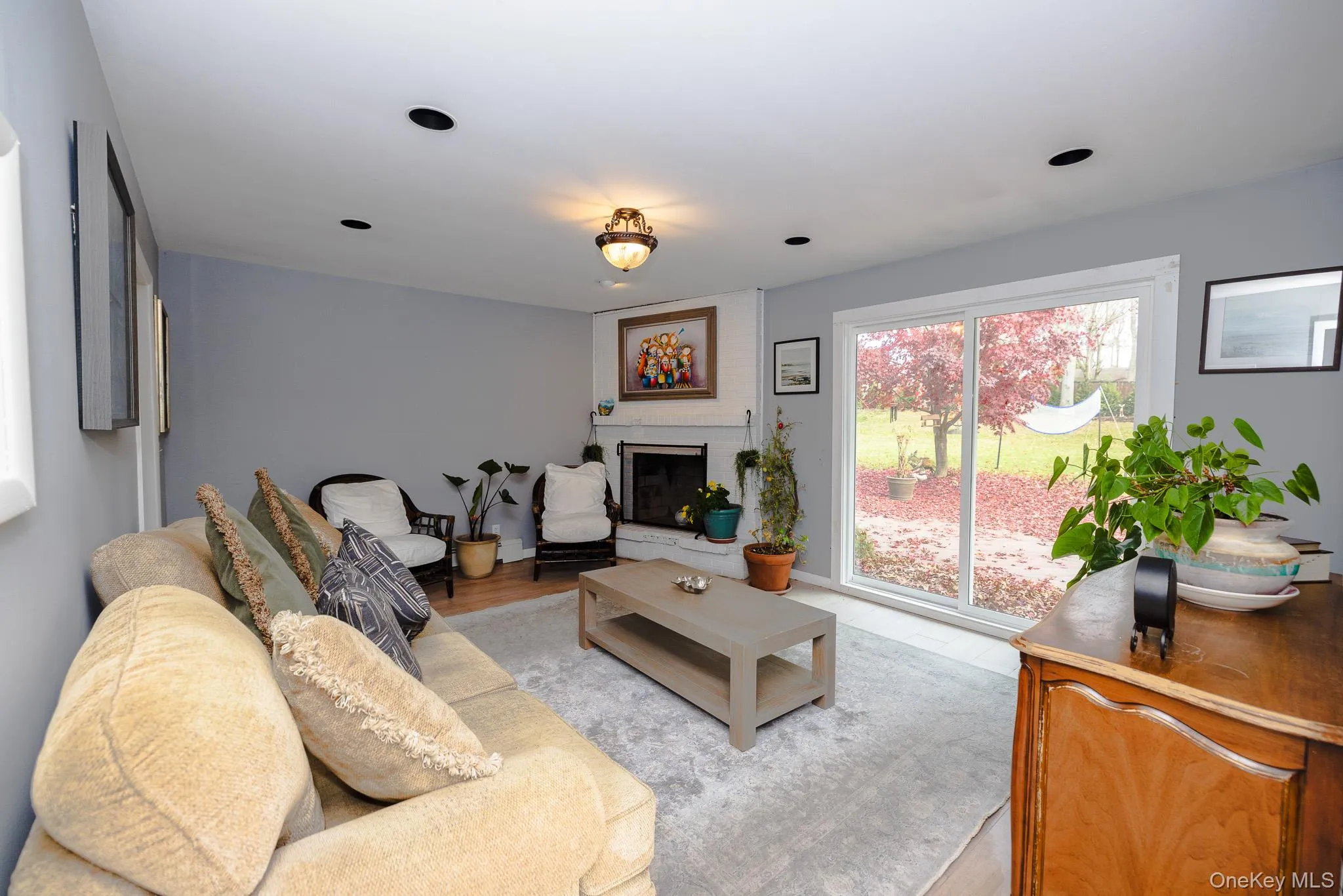 Living area featuring a fireplace and light wood-style floors Living area featuring a fireplace and light wood-style floors