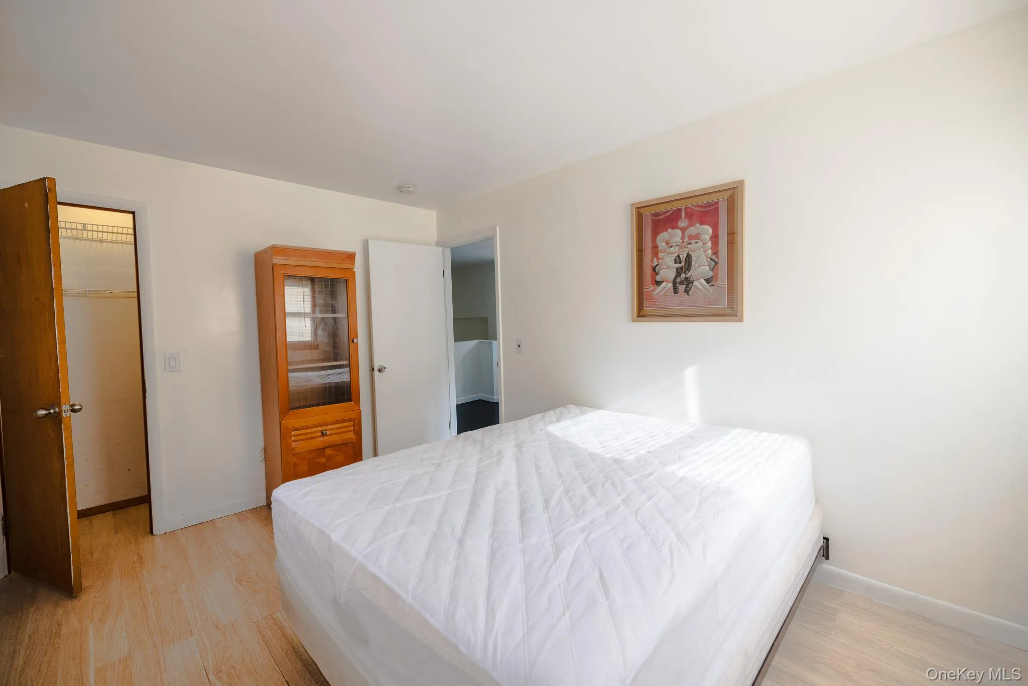 Bedroom featuring light wood finished floors and baseboards Bedroom featuring light wood finished floors and baseboards