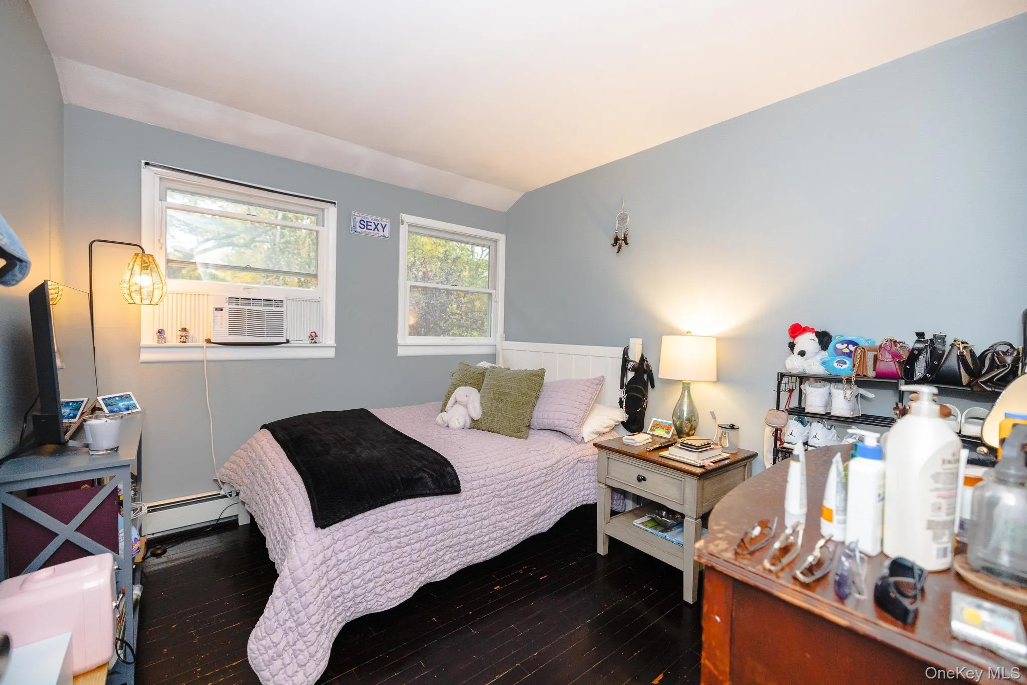 Bedroom featuring hardwood / wood-style flooring, baseboard heating, and lofted ceiling Bedroom featuring hardwood / wood-style flooring, baseboard heating, and lofted ceiling