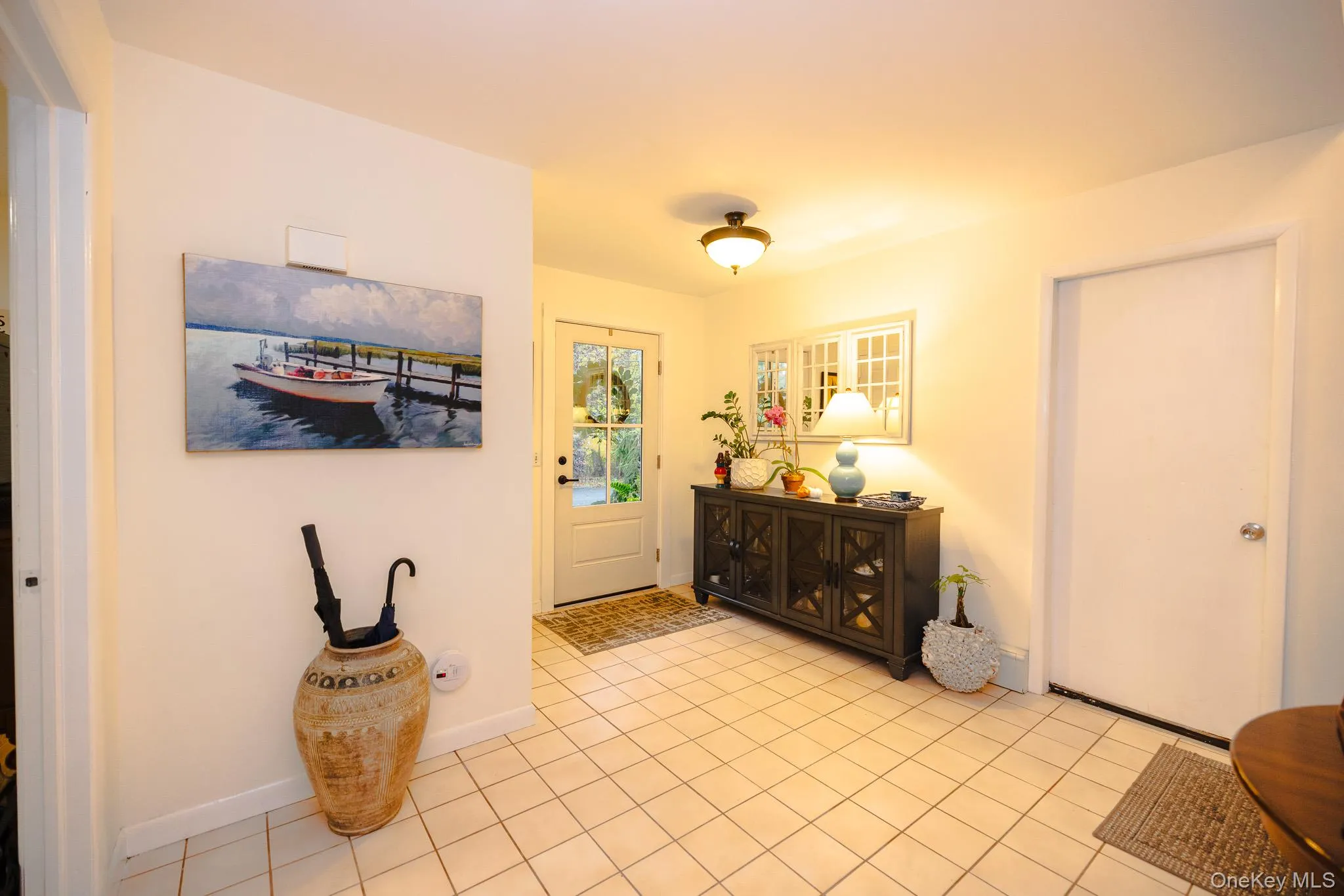Entrance foyer with light tile patterned floors and baseboards Entrance foyer with light tile patterned floors and baseboards