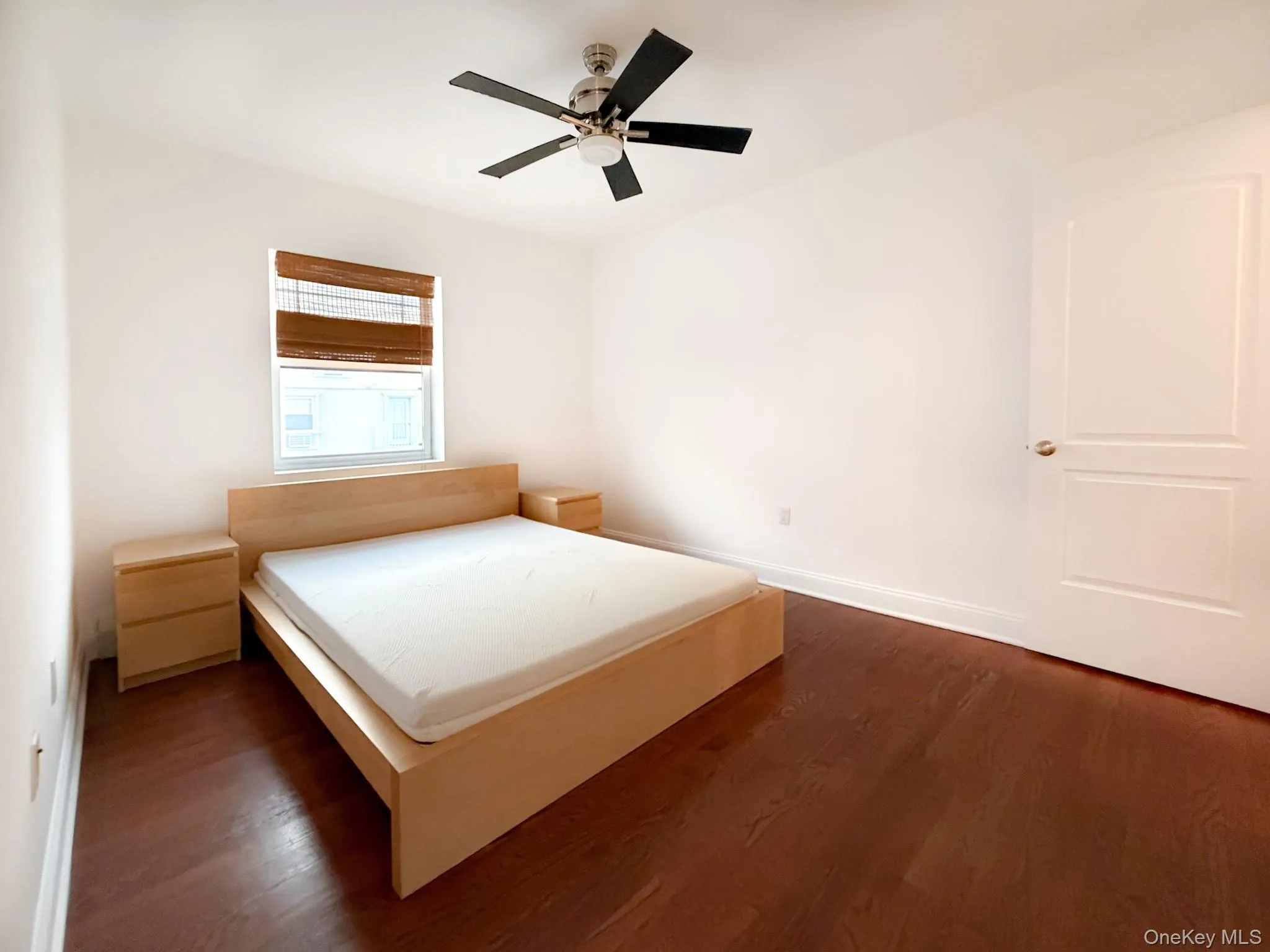 Bedroom featuring dark wood finished floors and a ceiling fan Bedroom featuring dark wood finished floors and a ceiling fan