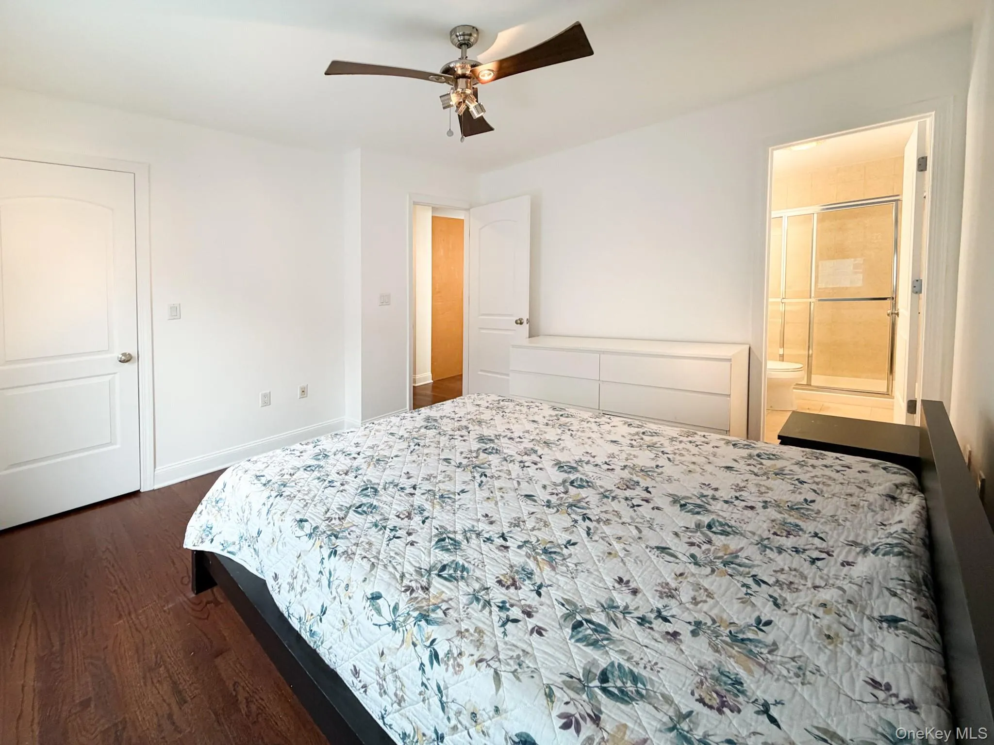 Bedroom featuring dark wood finished floors and ceiling fan Bedroom featuring dark wood finished floors and ceiling fan