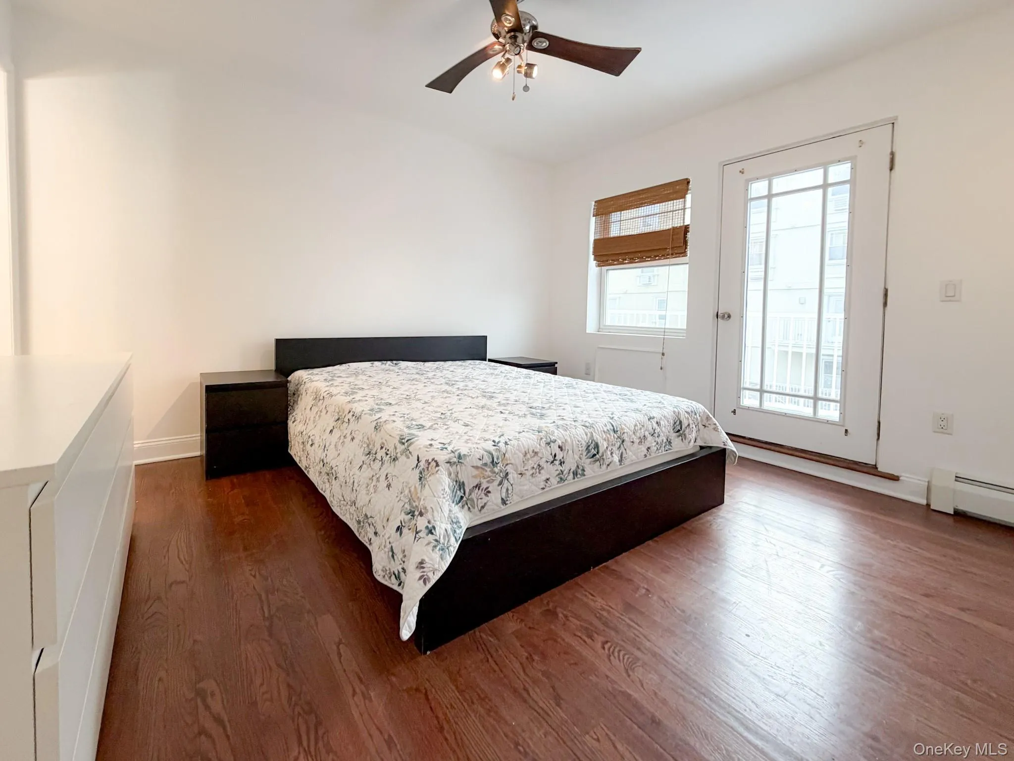 Bedroom with access to outside, dark wood finished floors, and a ceiling fan Bedroom with access to outside, dark wood finished floors, and a ceiling fan
