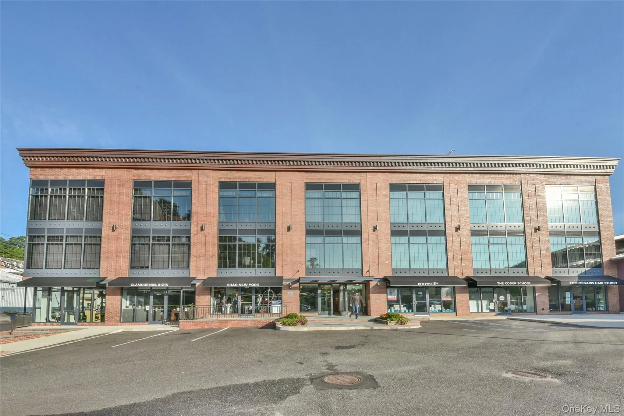 View of commercial property with uncovered parking View of commercial property with uncovered parking