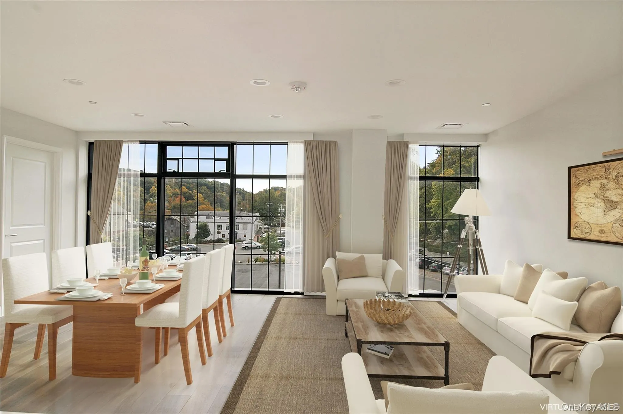 Living area featuring wood finished floors, plenty of natural light, a wall of windows, and recessed lighting Living area featuring wood finished floors, plenty of natural light, a wall of windows, and recessed lighting