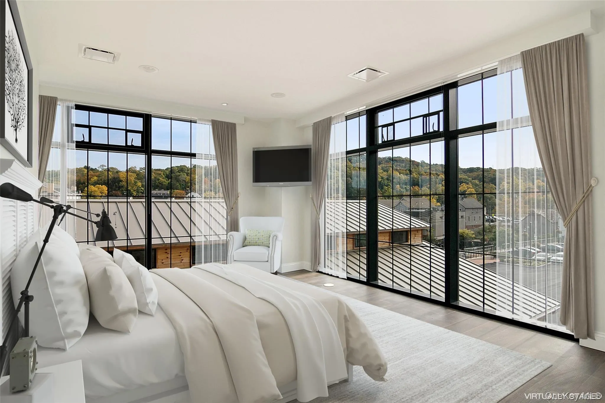 Bedroom with wood finished floors, access to exterior, and multiple windows Bedroom with wood finished floors, access to exterior, and multiple windows